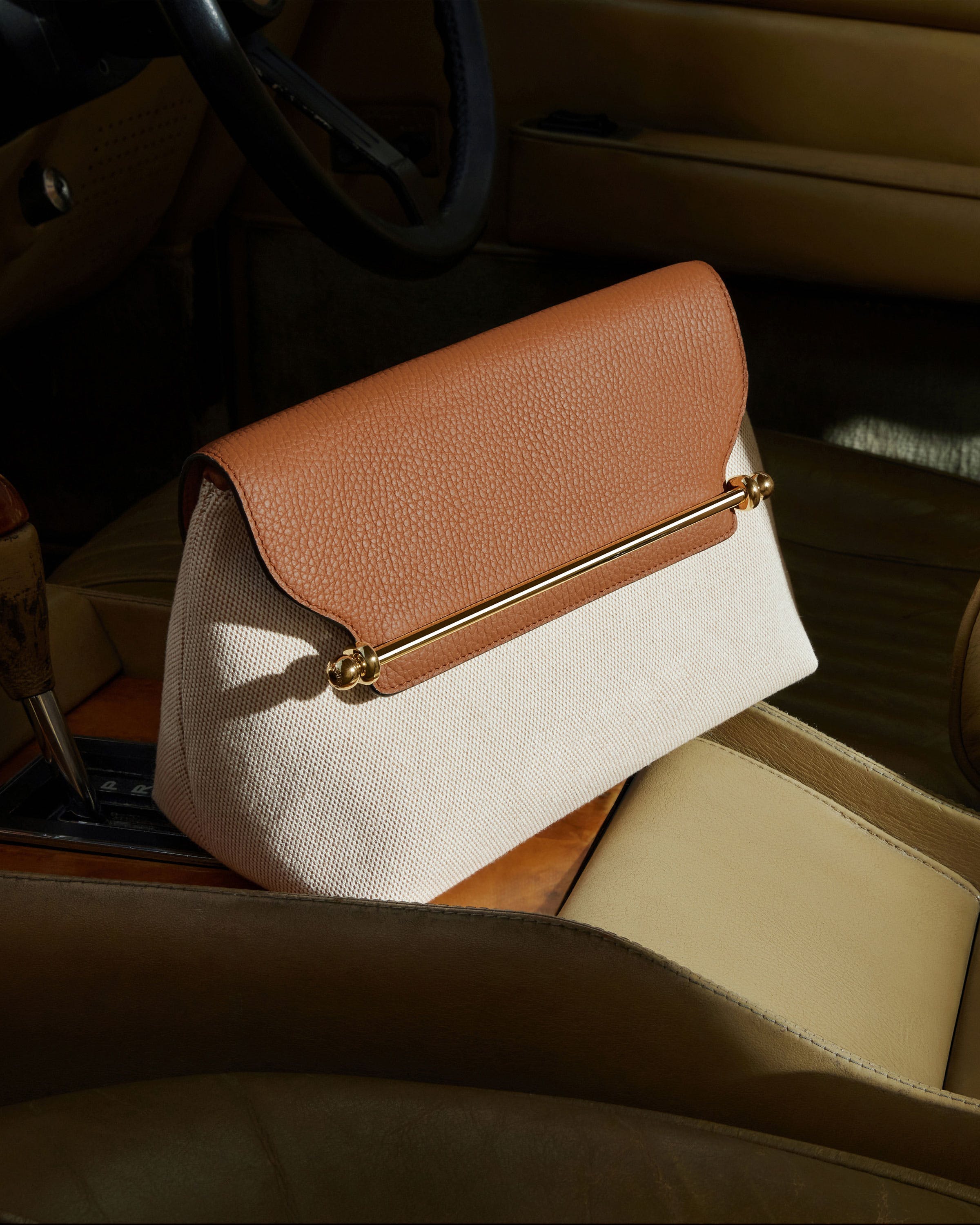 A brown and white purse sitting on top of a table