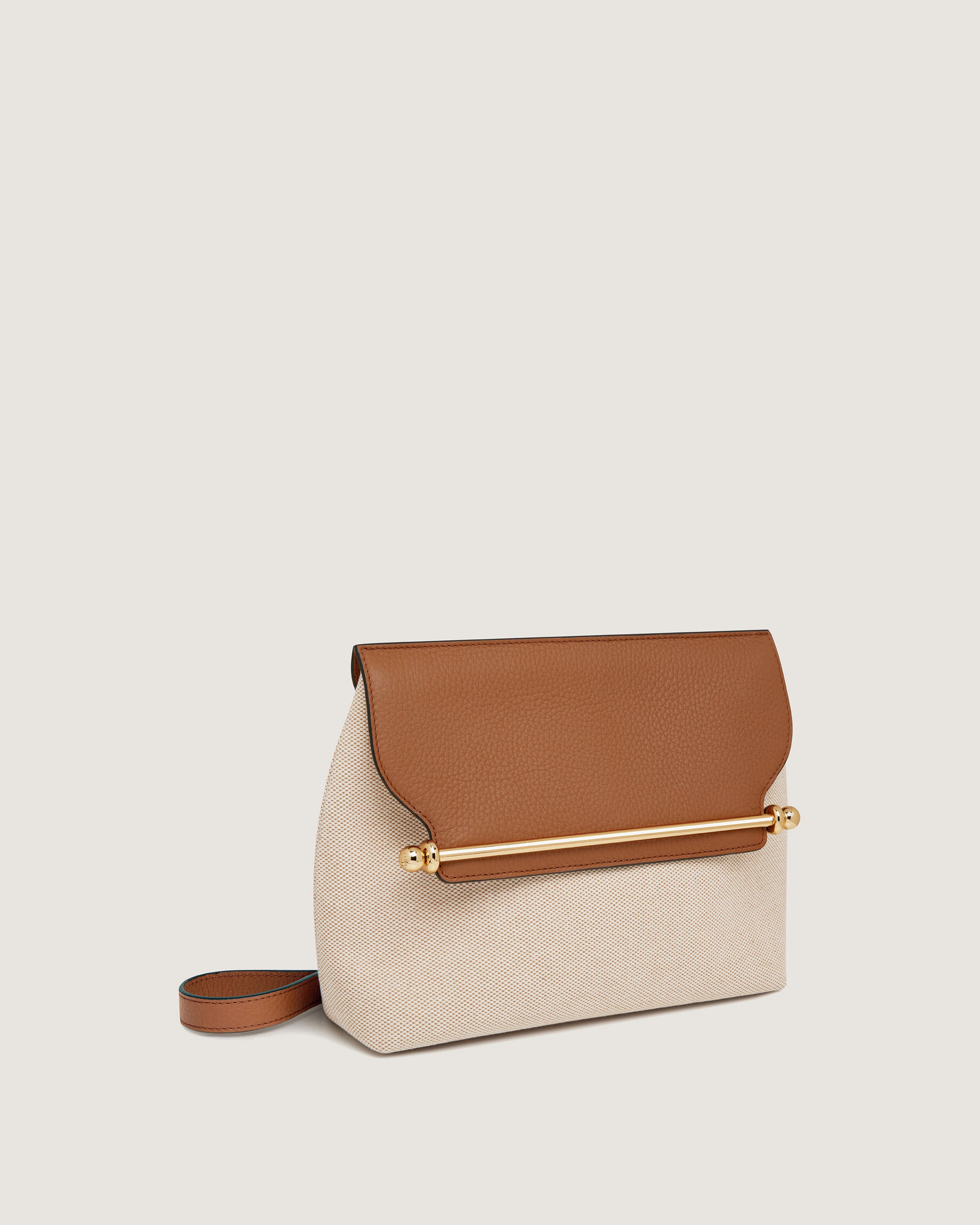 A white and brown purse sitting on top of a table