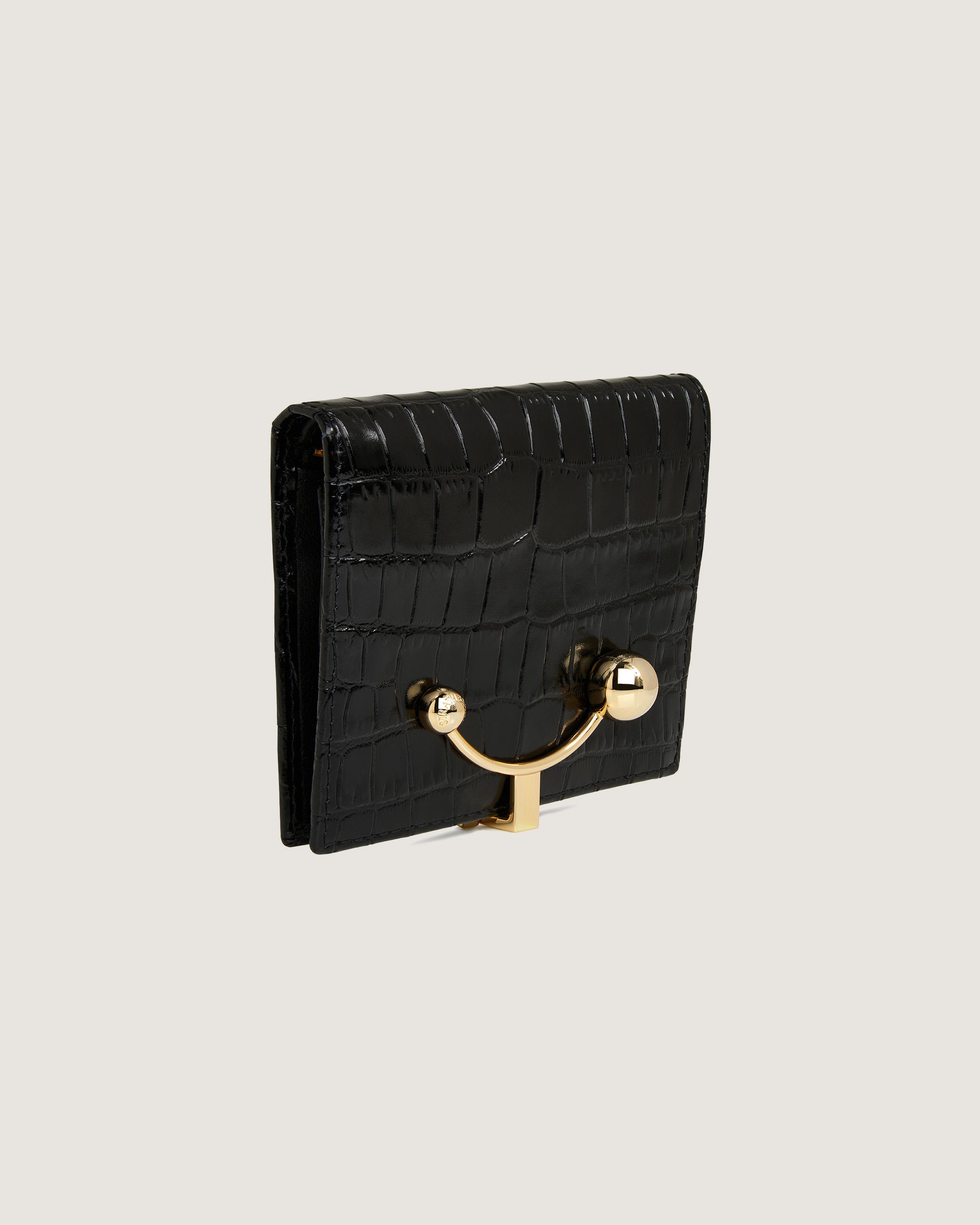 A black purse with a gold handle