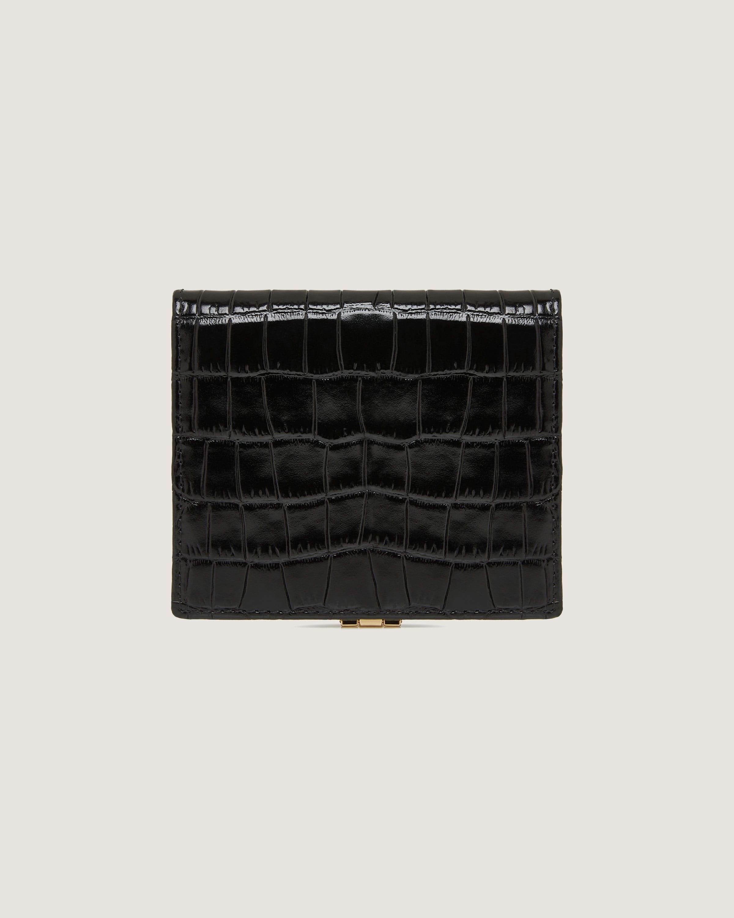 A black alligator skin wallet with a gold clasp