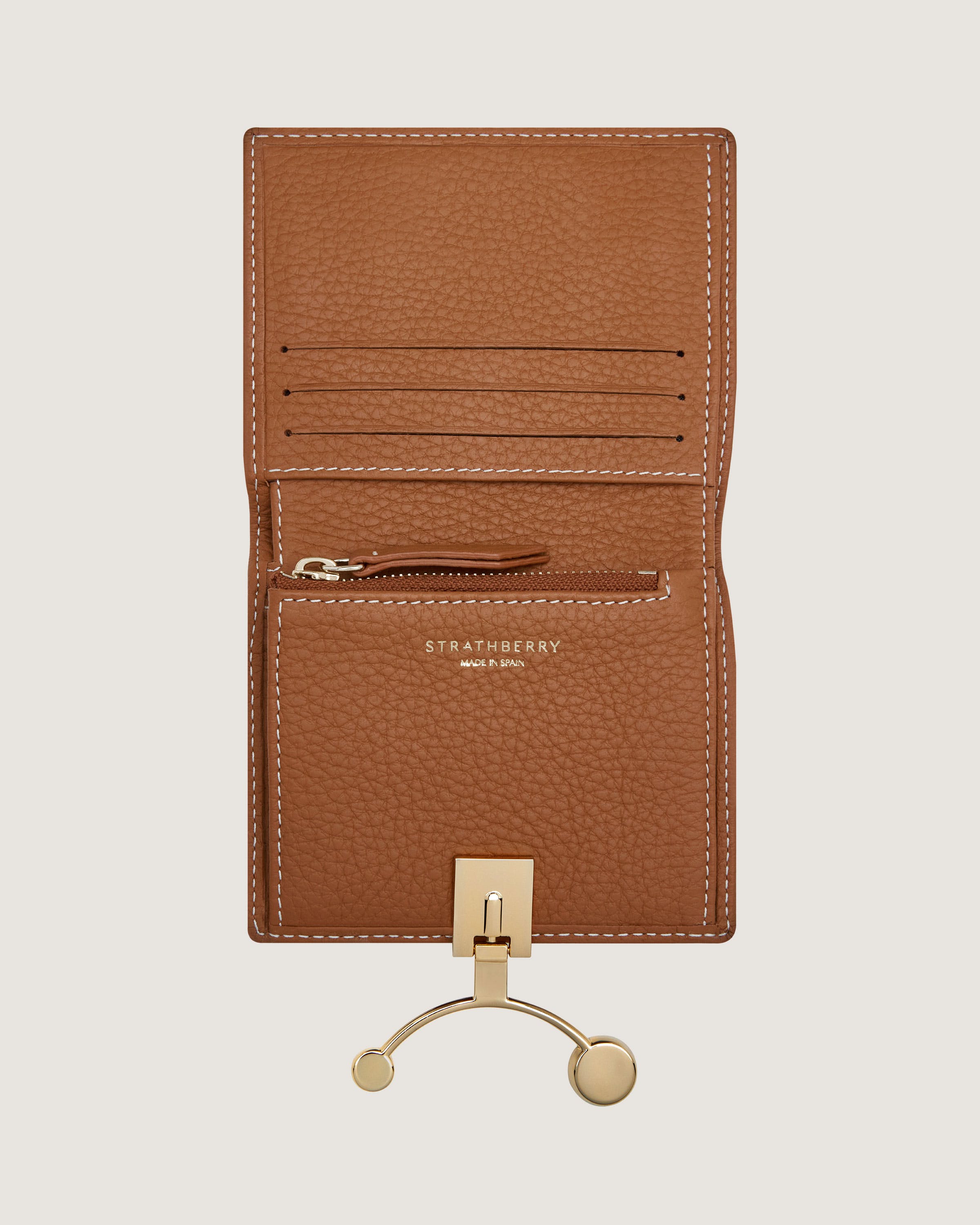 A brown card case with a gold hook