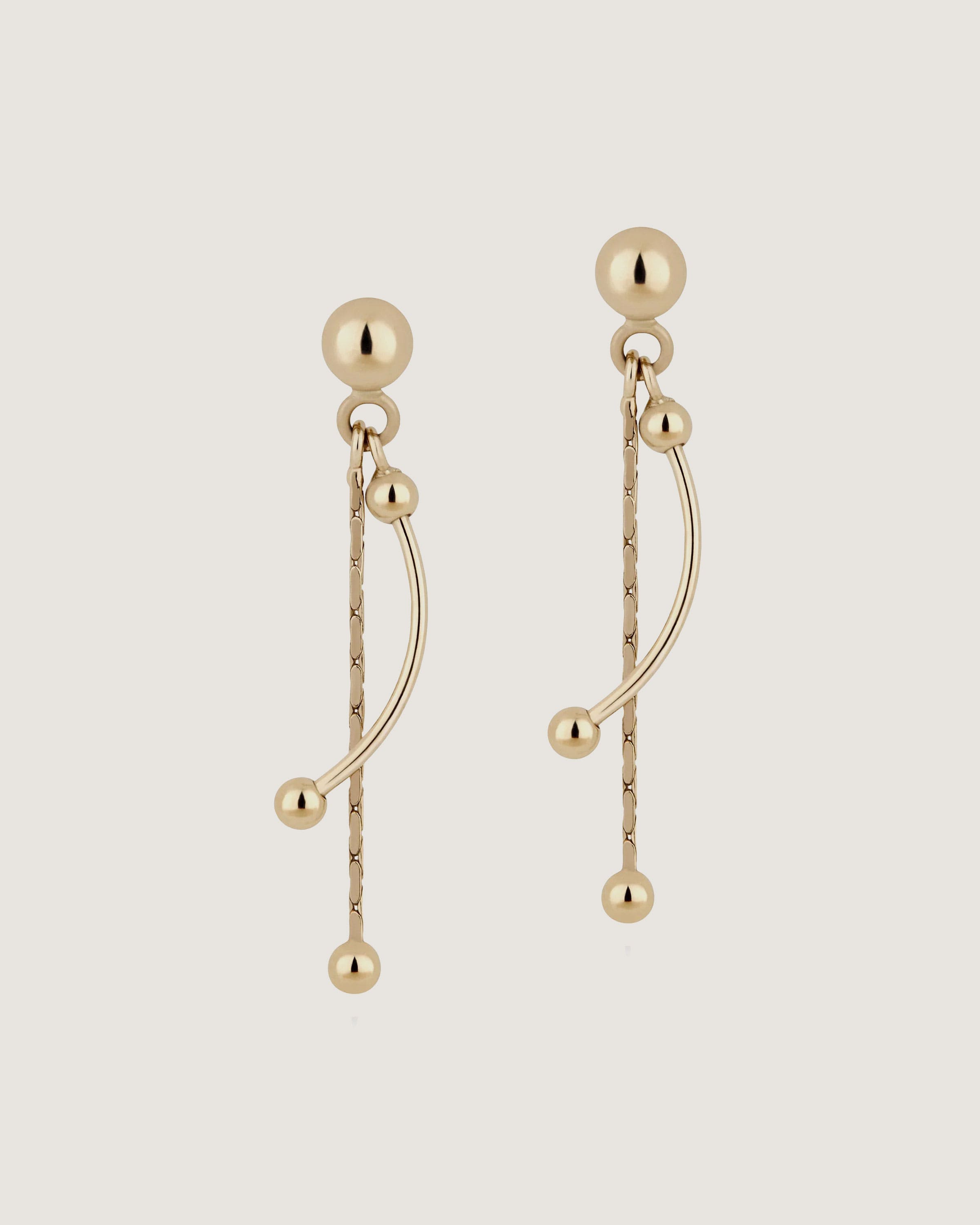 A pair of gold earrings with beads