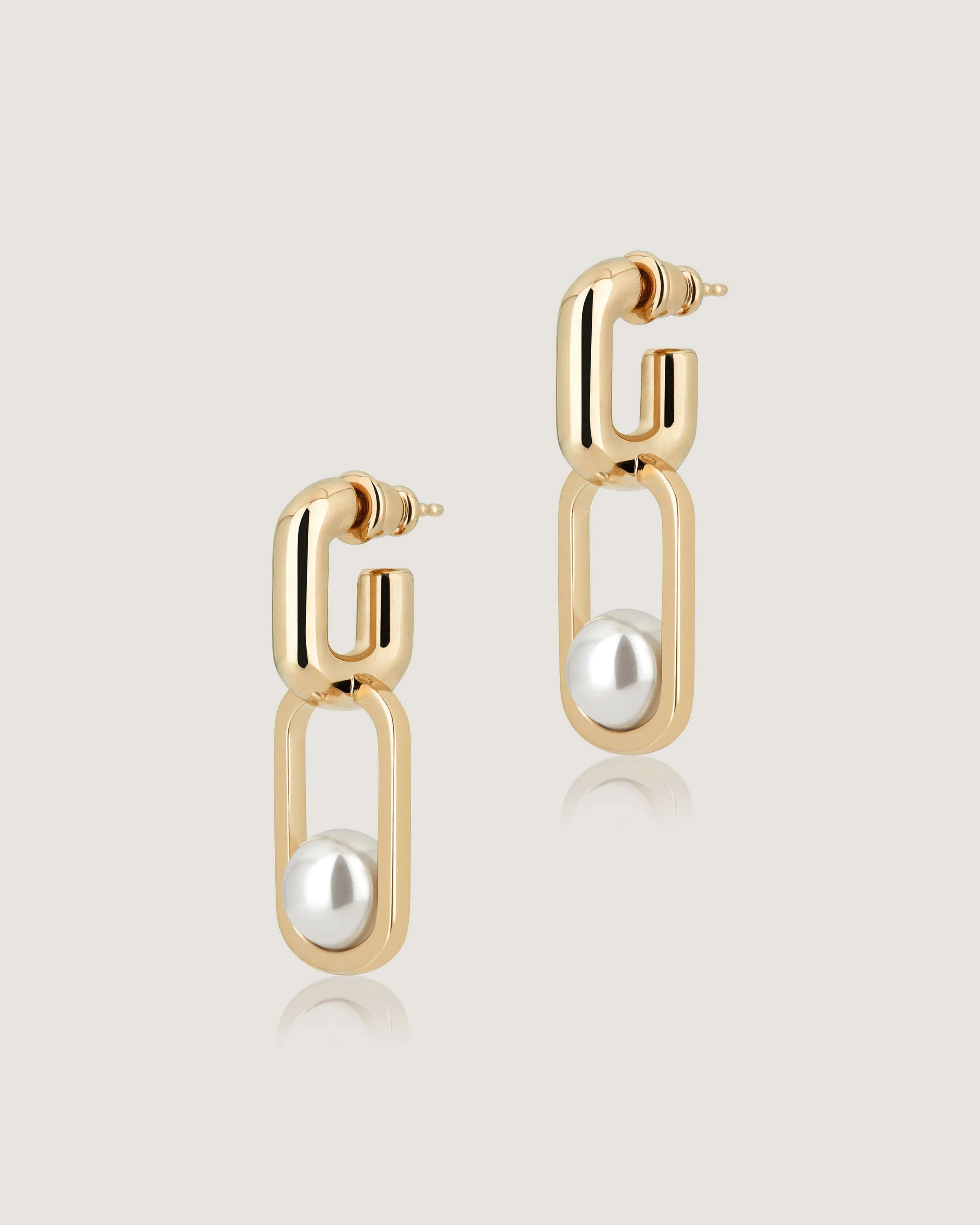 A pair of gold earrings with pearls