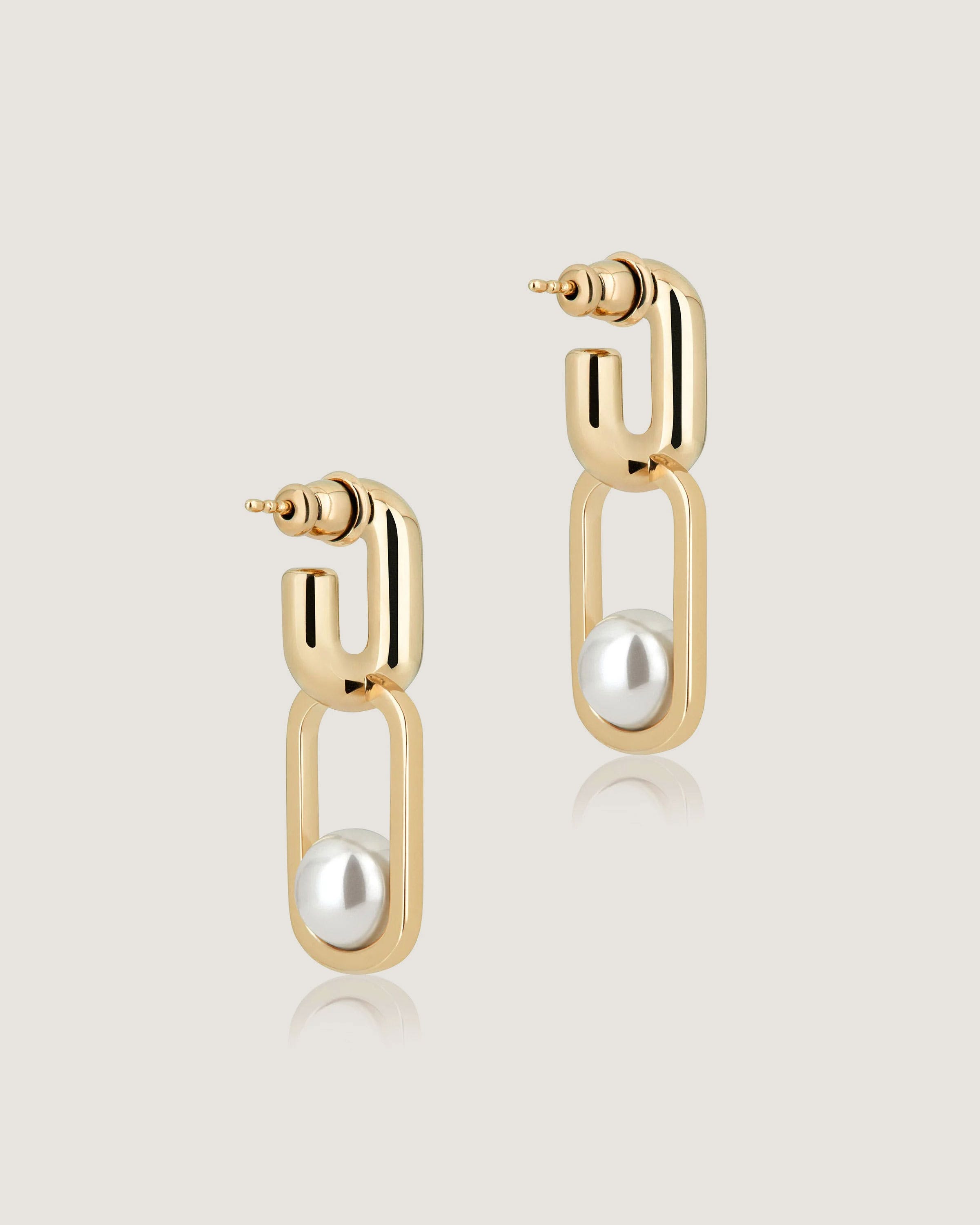 A pair of gold earrings with pearls