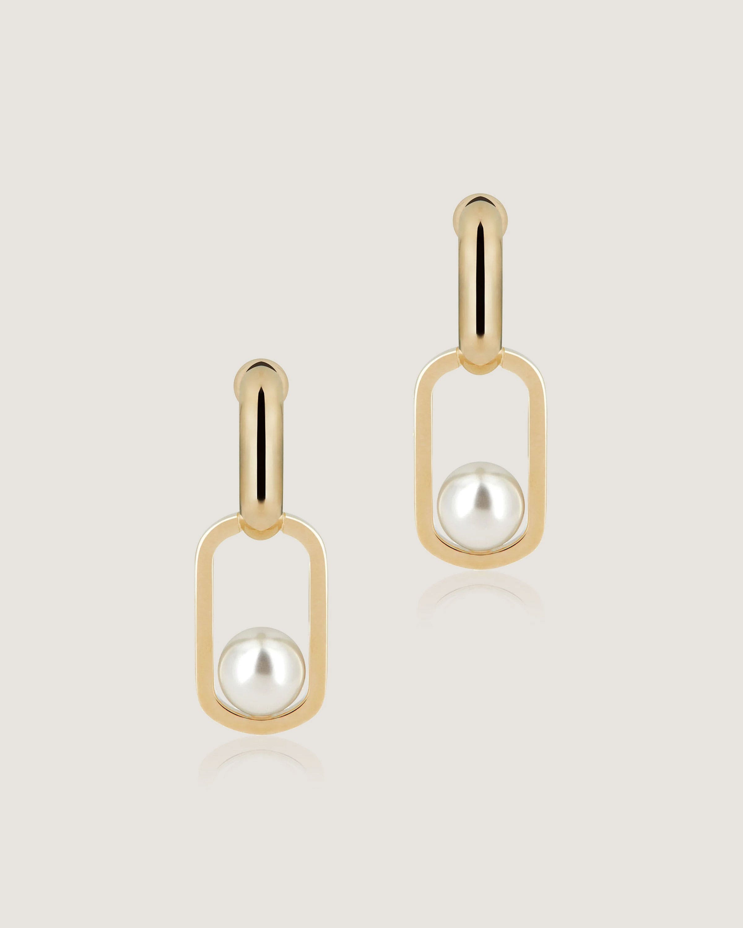 A pair of gold earrings with pearls