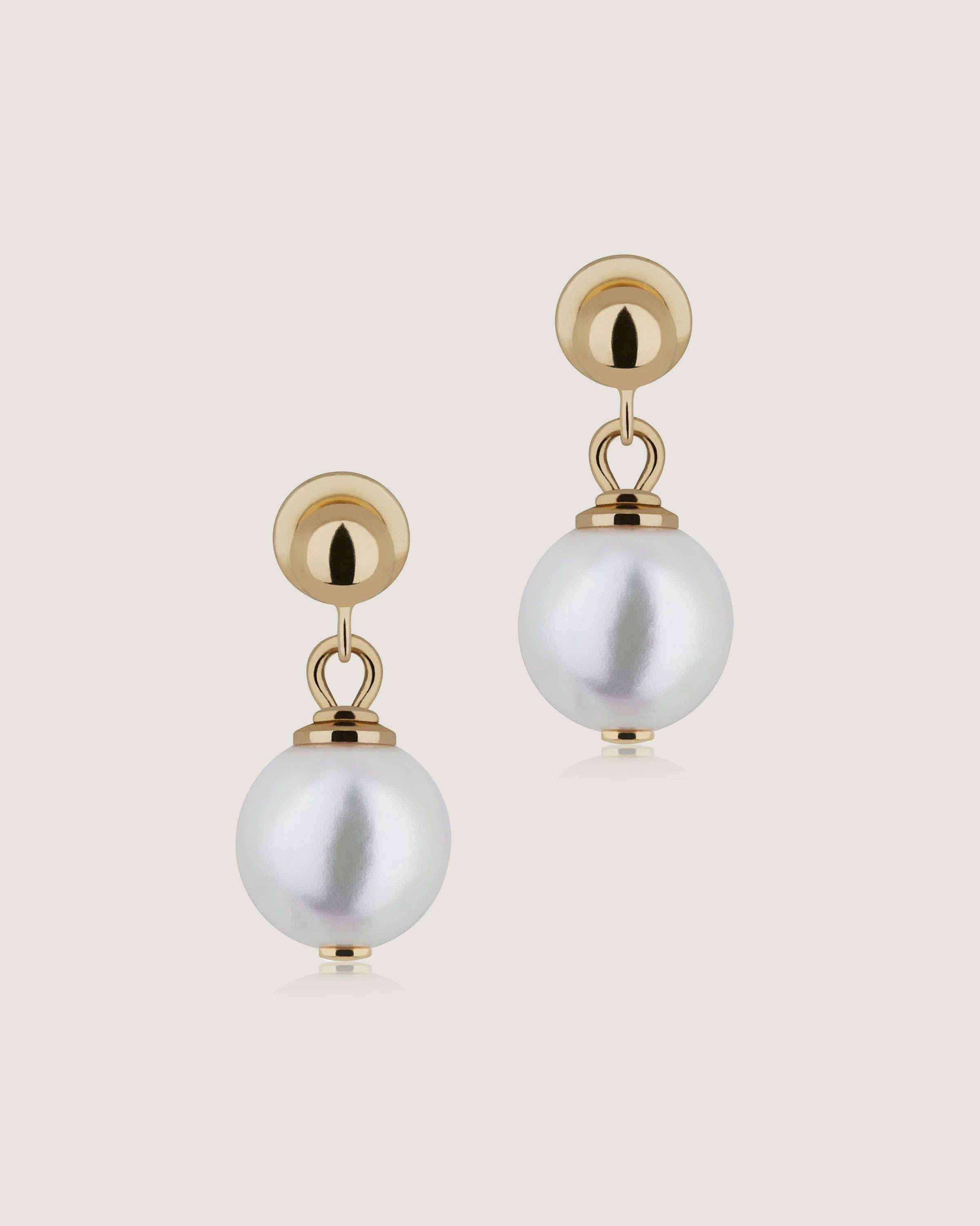 A pair of gold and white earrings