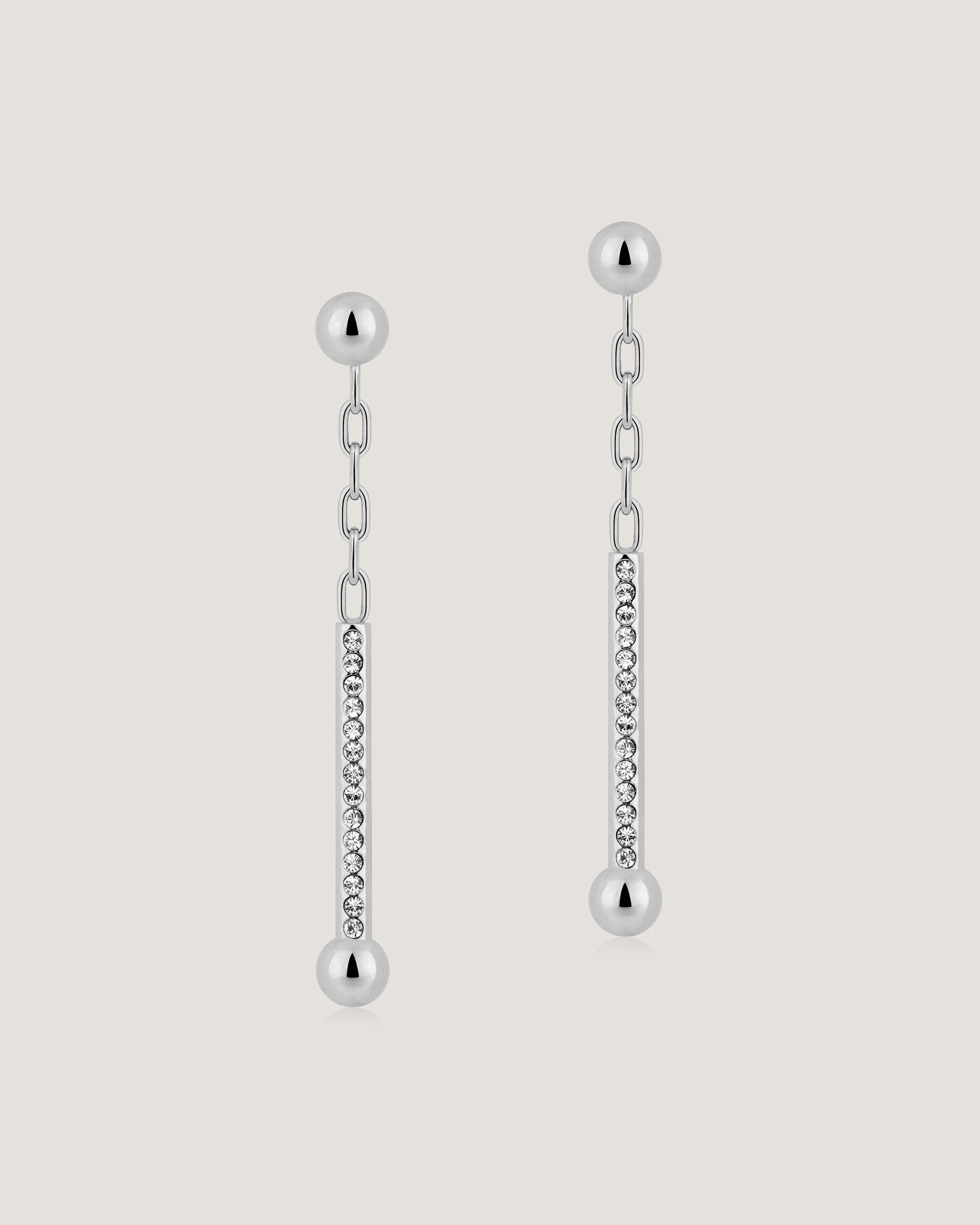 A pair of earrings with a chain hanging from it