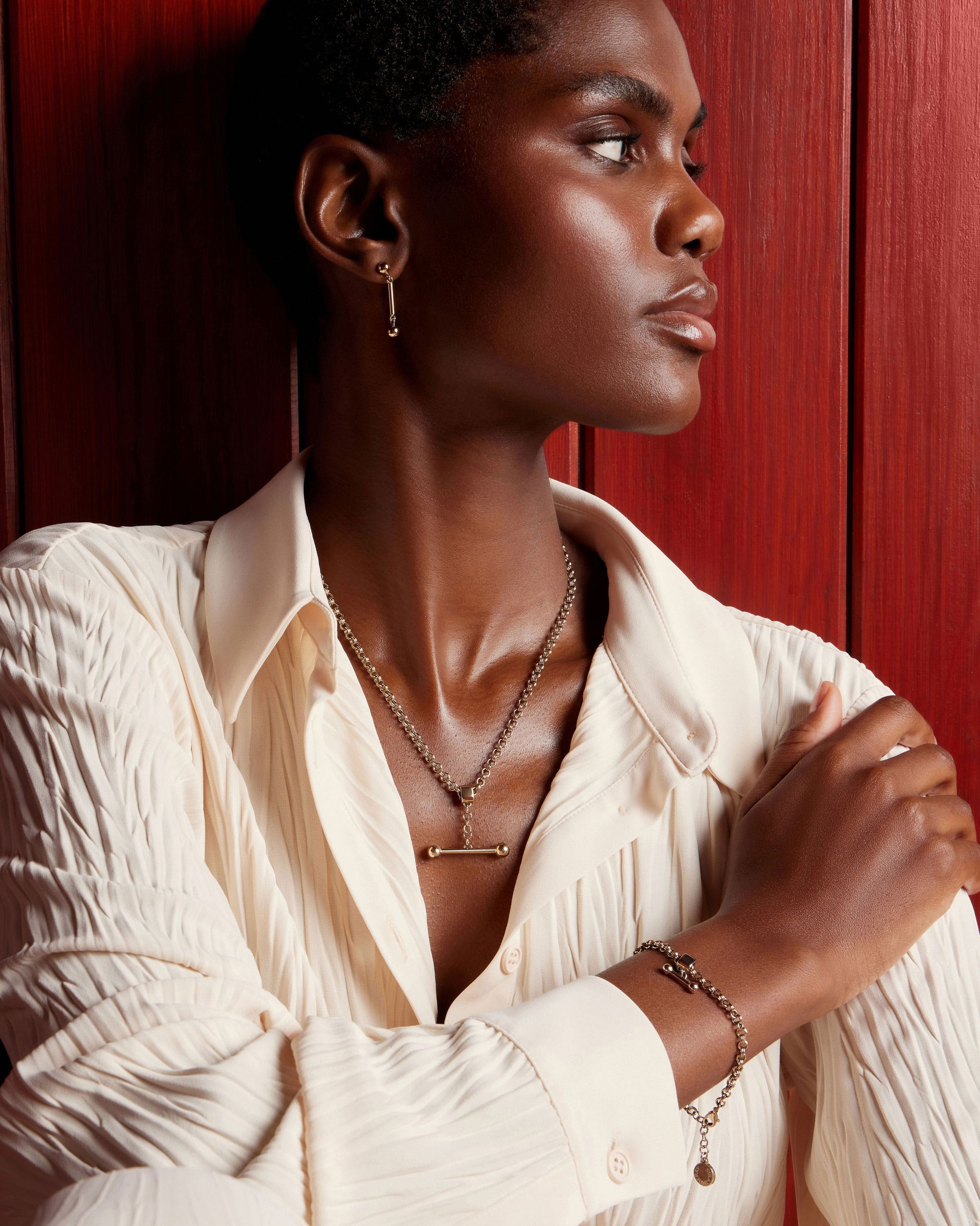 A woman wearing a white shirt and a necklace