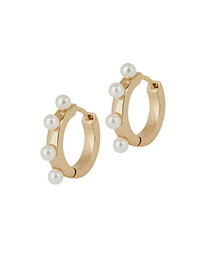A pair of gold hoop earrings with pearls