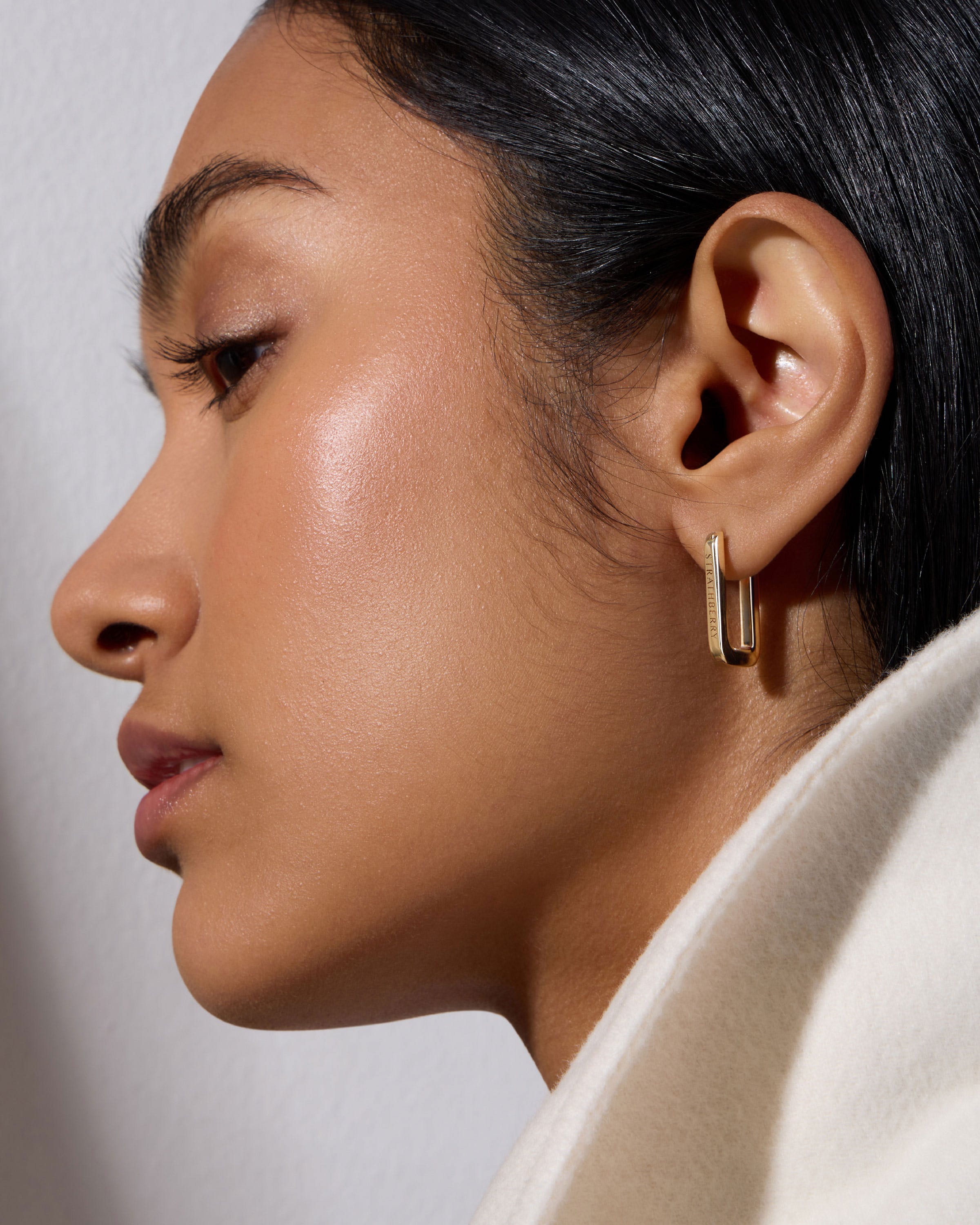 A close up of a person wearing a pair of earrings