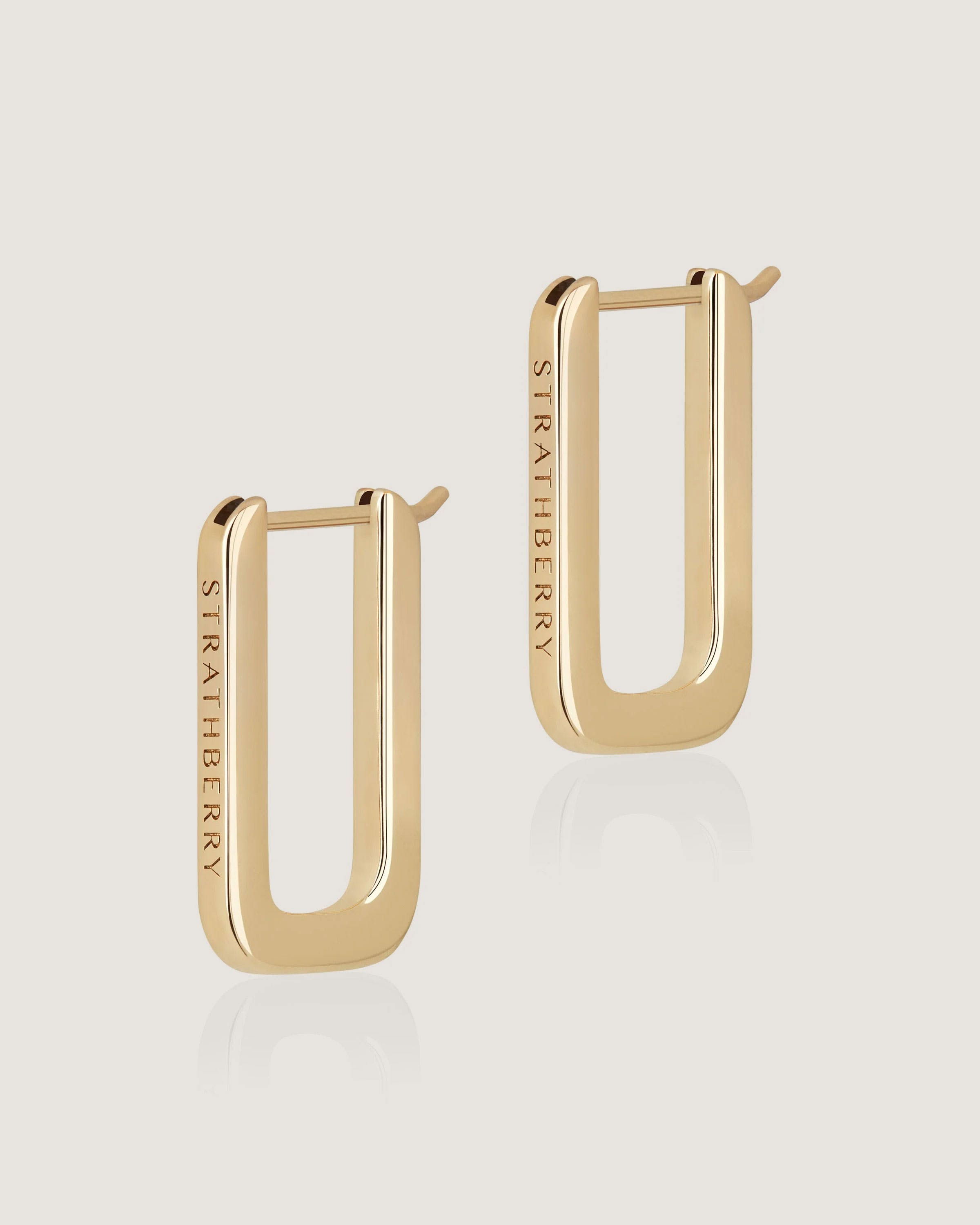 A pair of gold earrings with a rectangular design