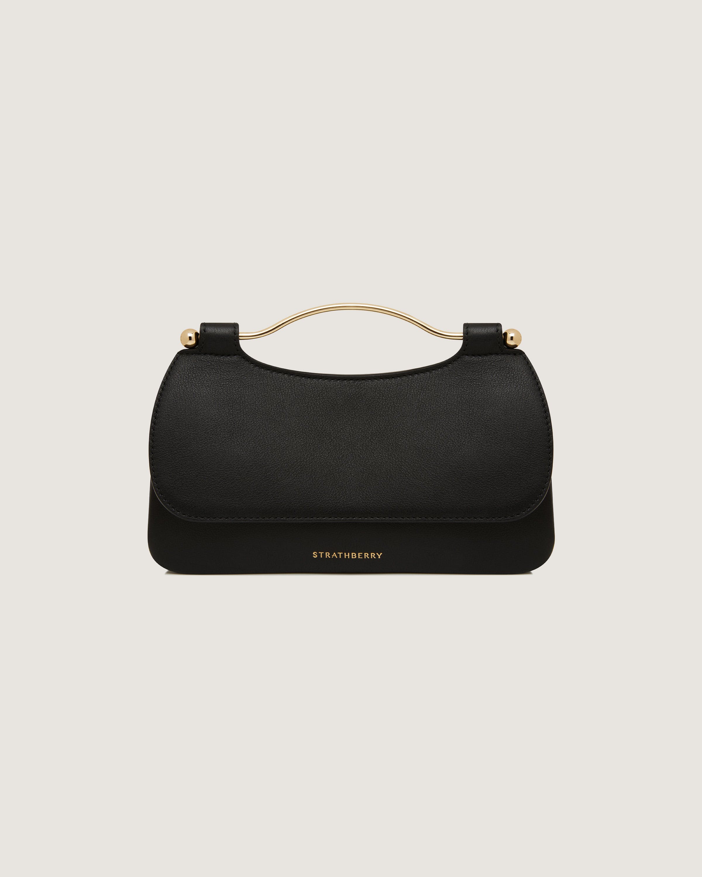 A black handbag with a gold handle