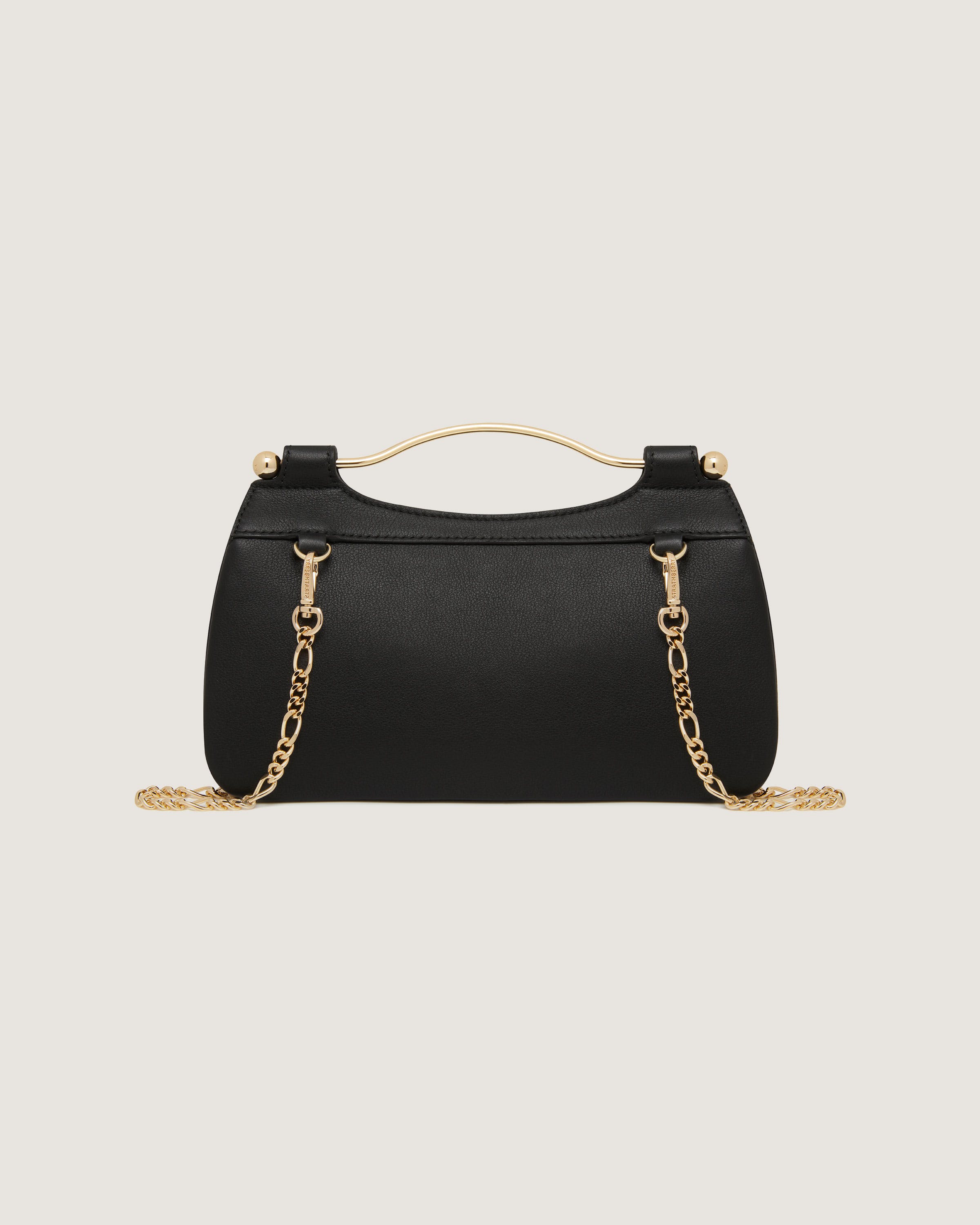 A black handbag with a gold chain strap