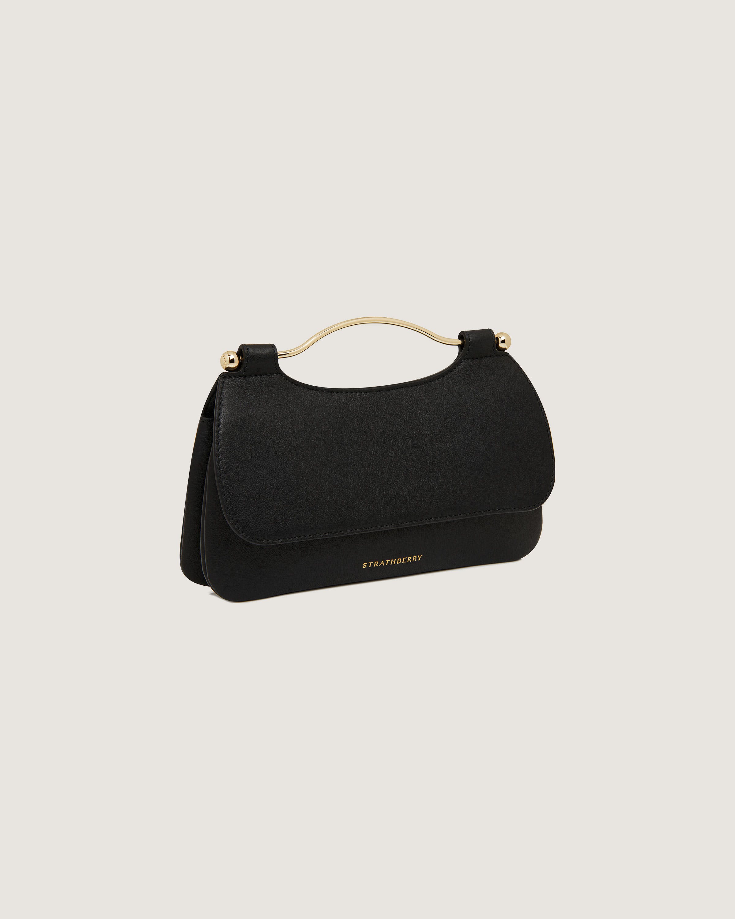 A black handbag with a gold handle