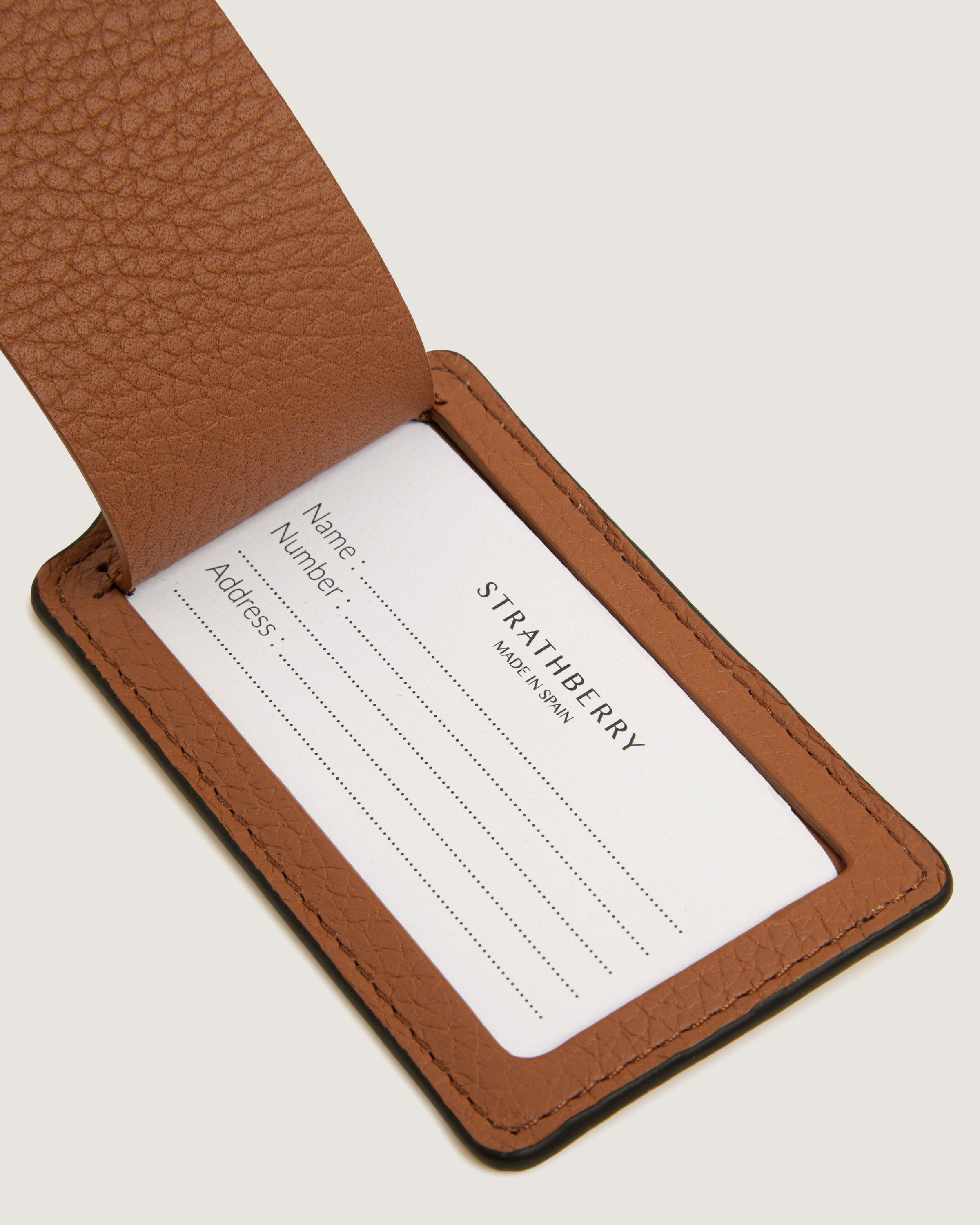 A brown leather business card holder