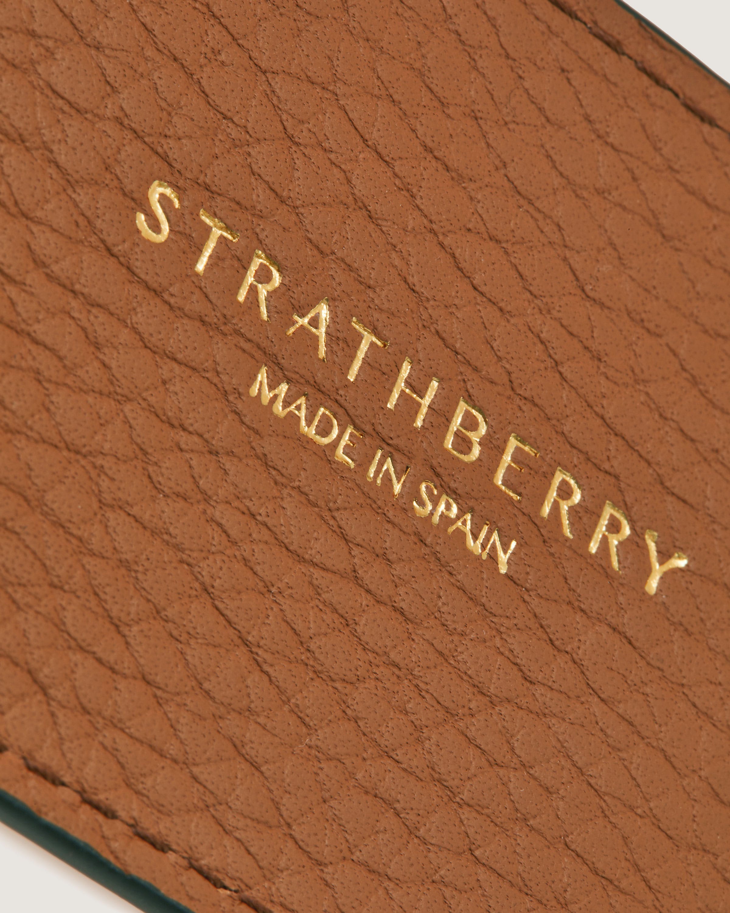 A brown leather case with a name on it