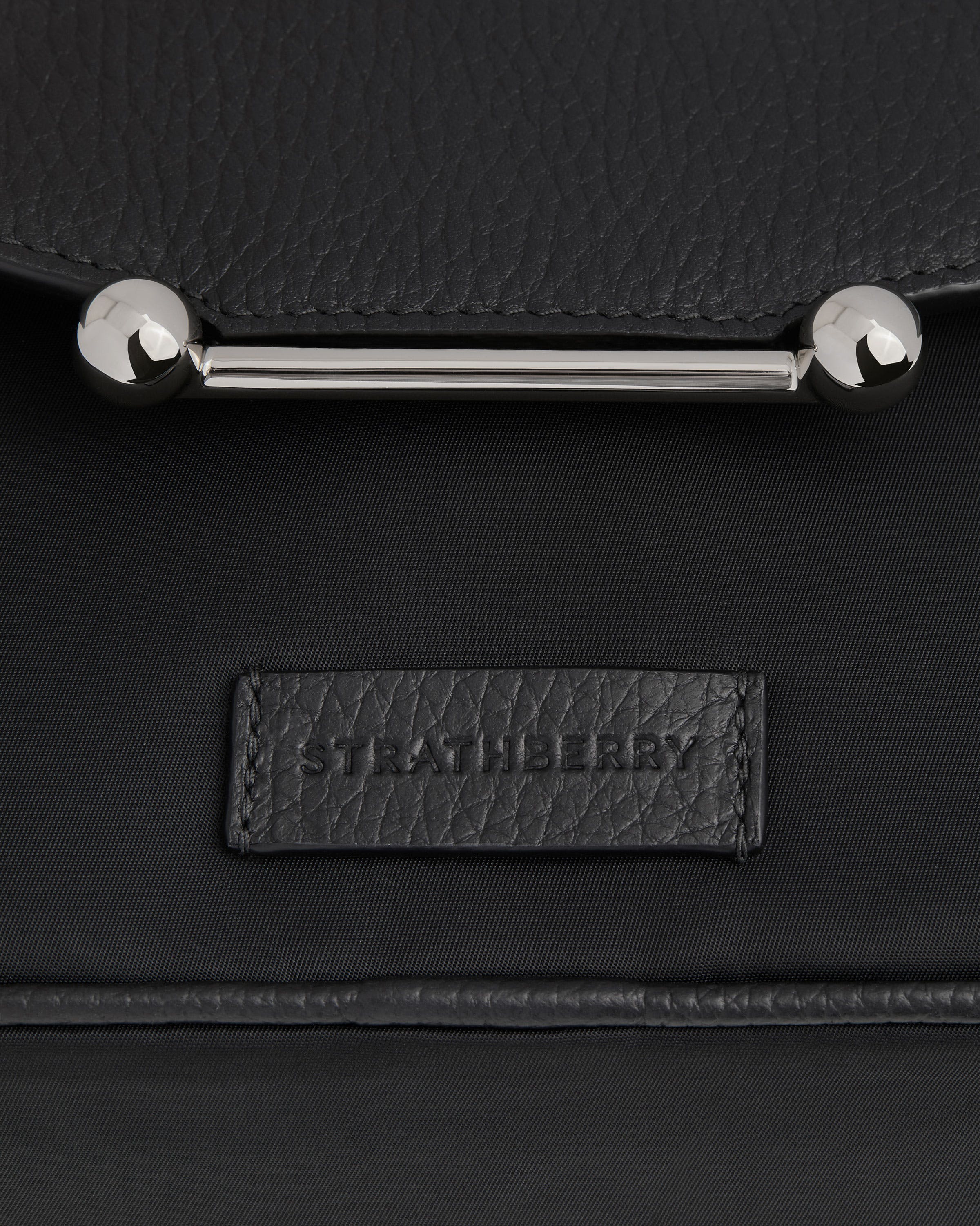 A black leather bag with a metal handle