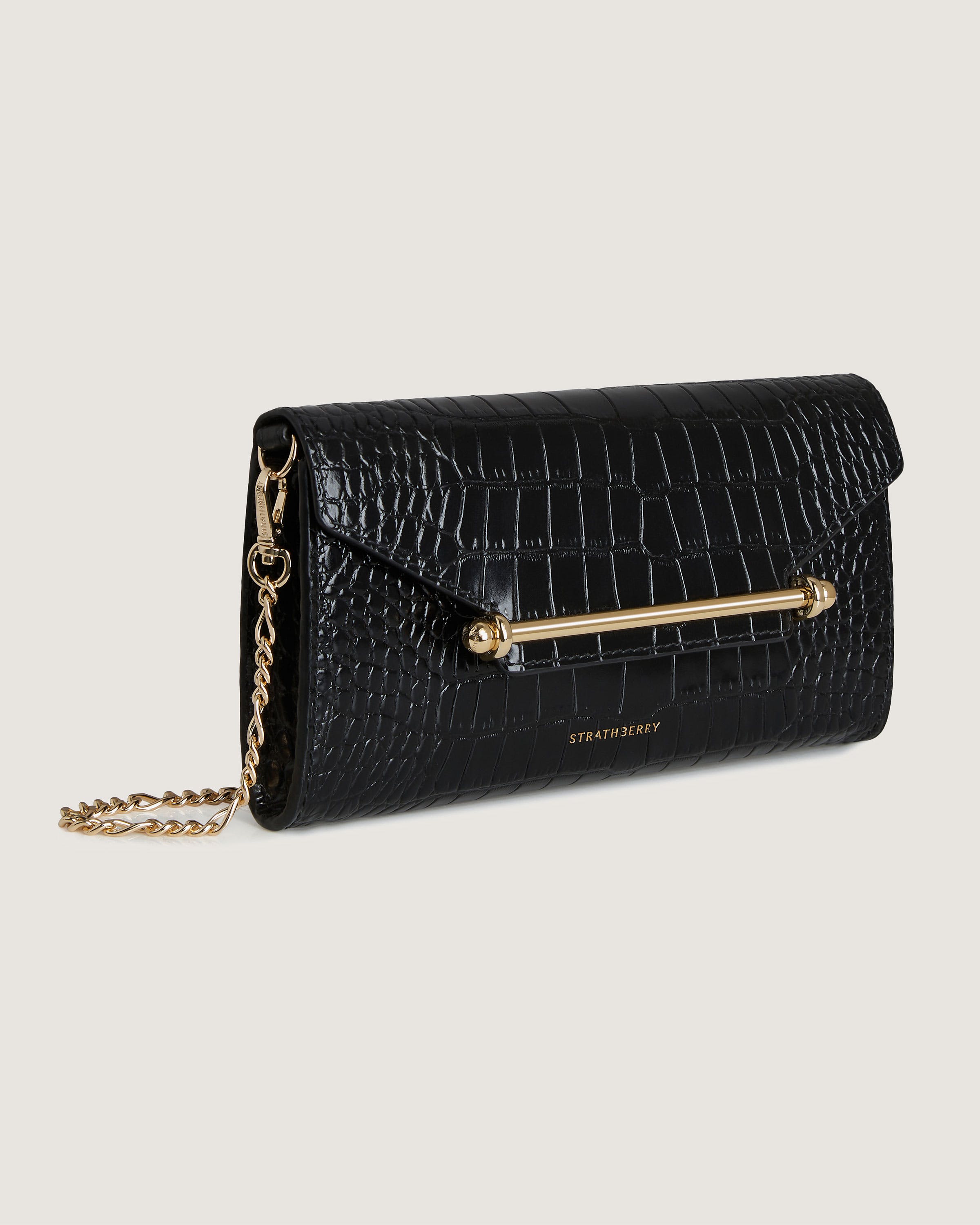 A black purse with a gold chain