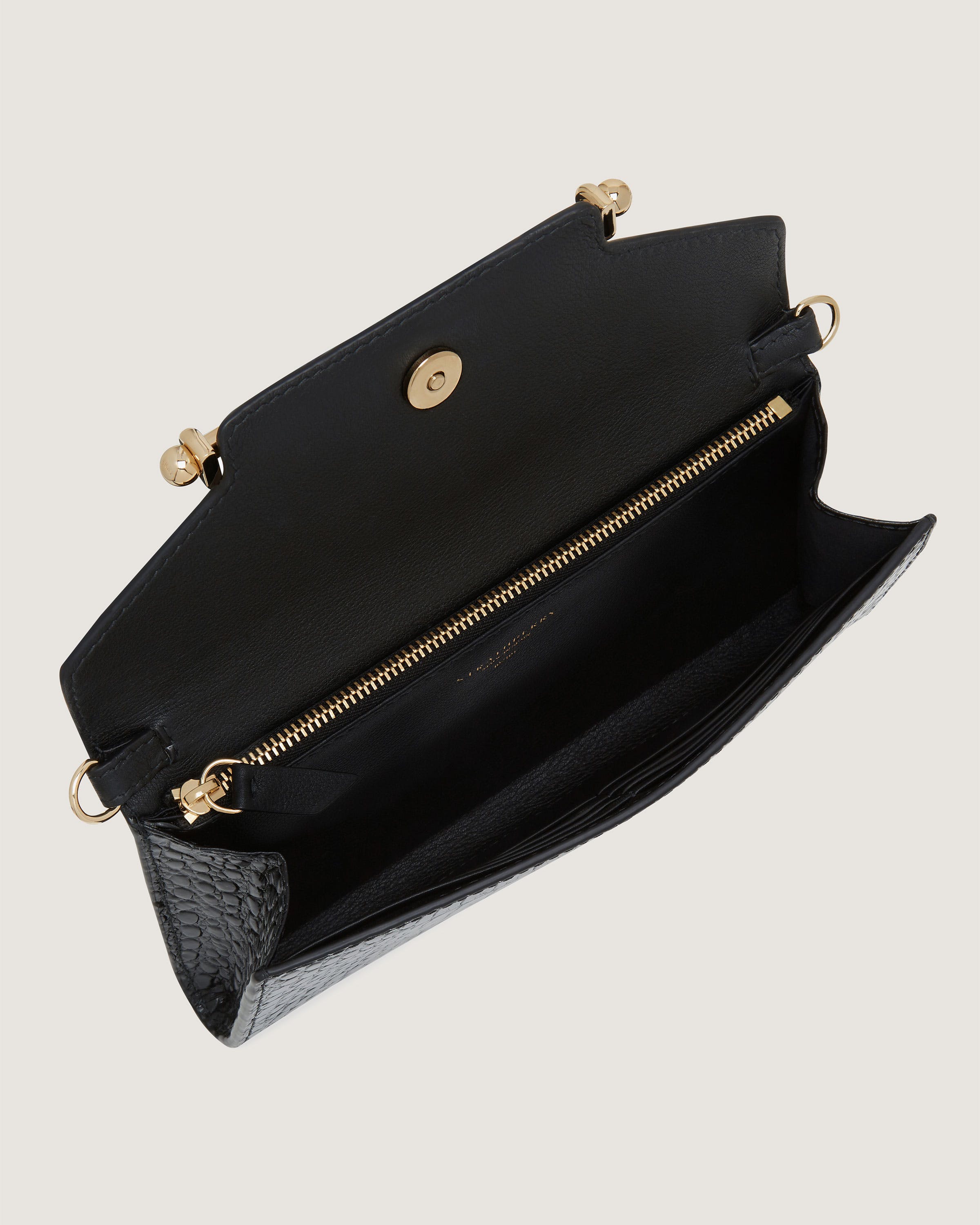 A black purse with a gold zipper