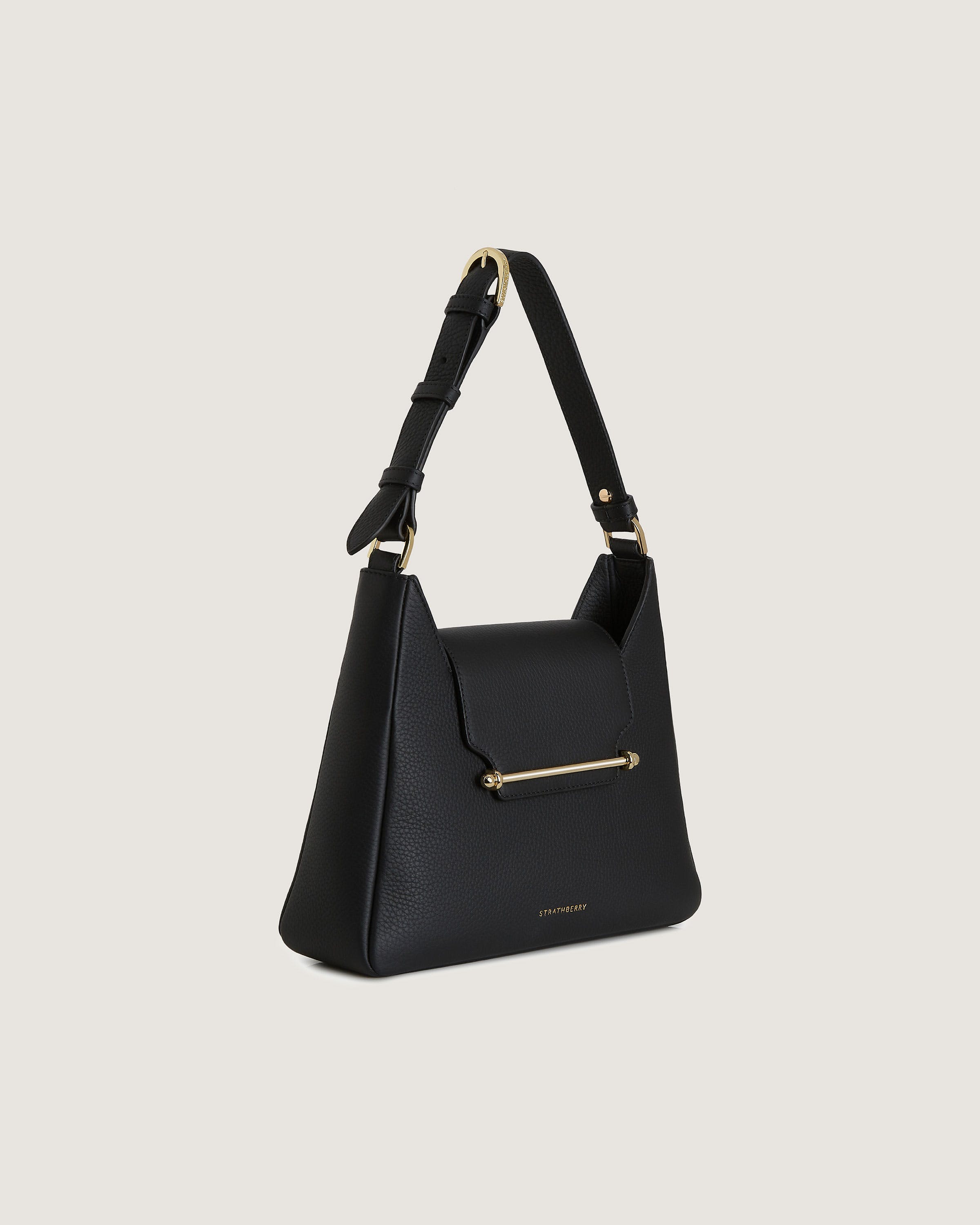 A black handbag with a gold handle