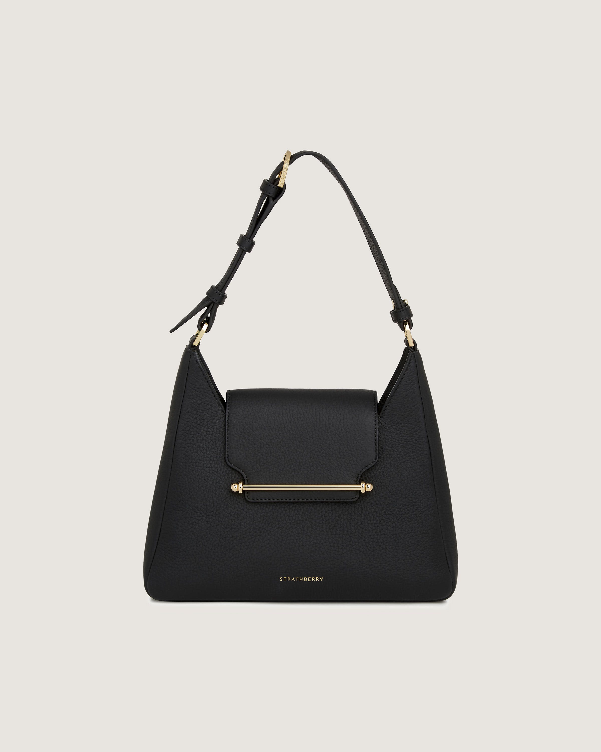 A black handbag with a gold handle