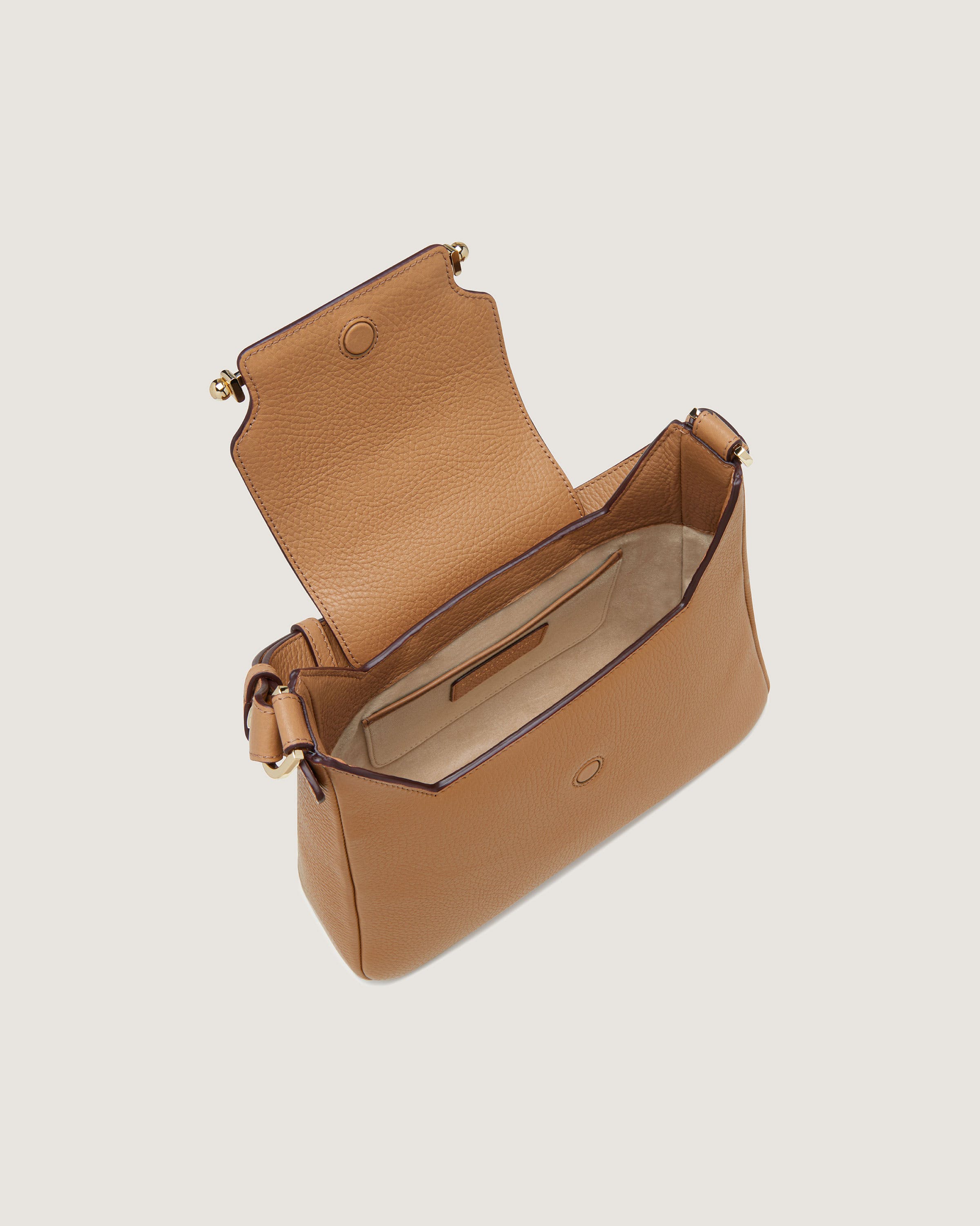 A tan handbag with a handle on the inside of it