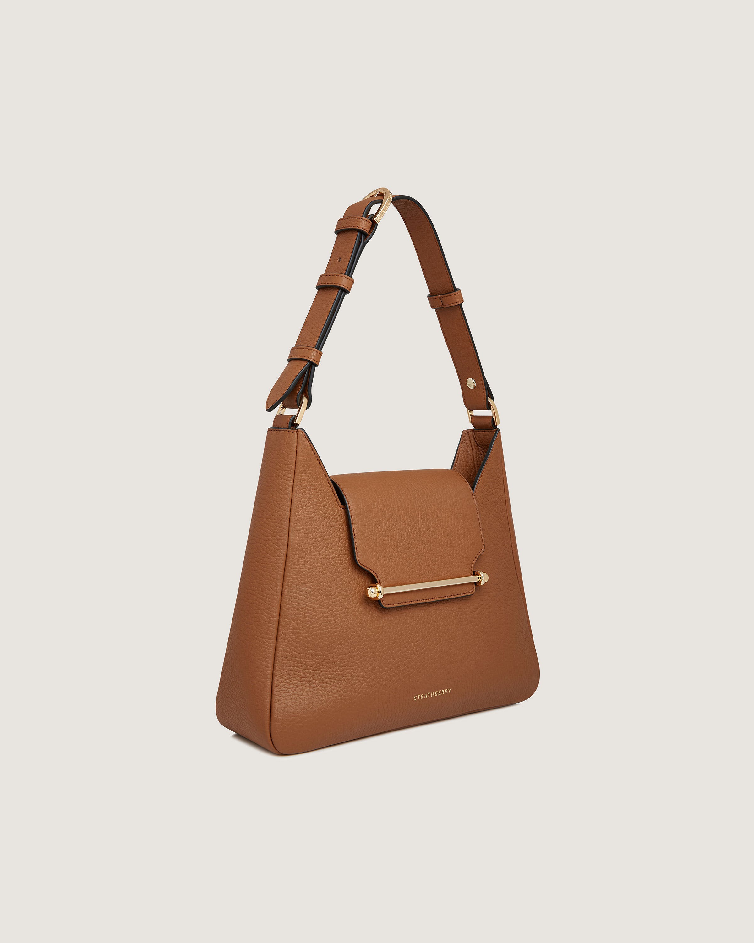 A brown handbag with a gold handle