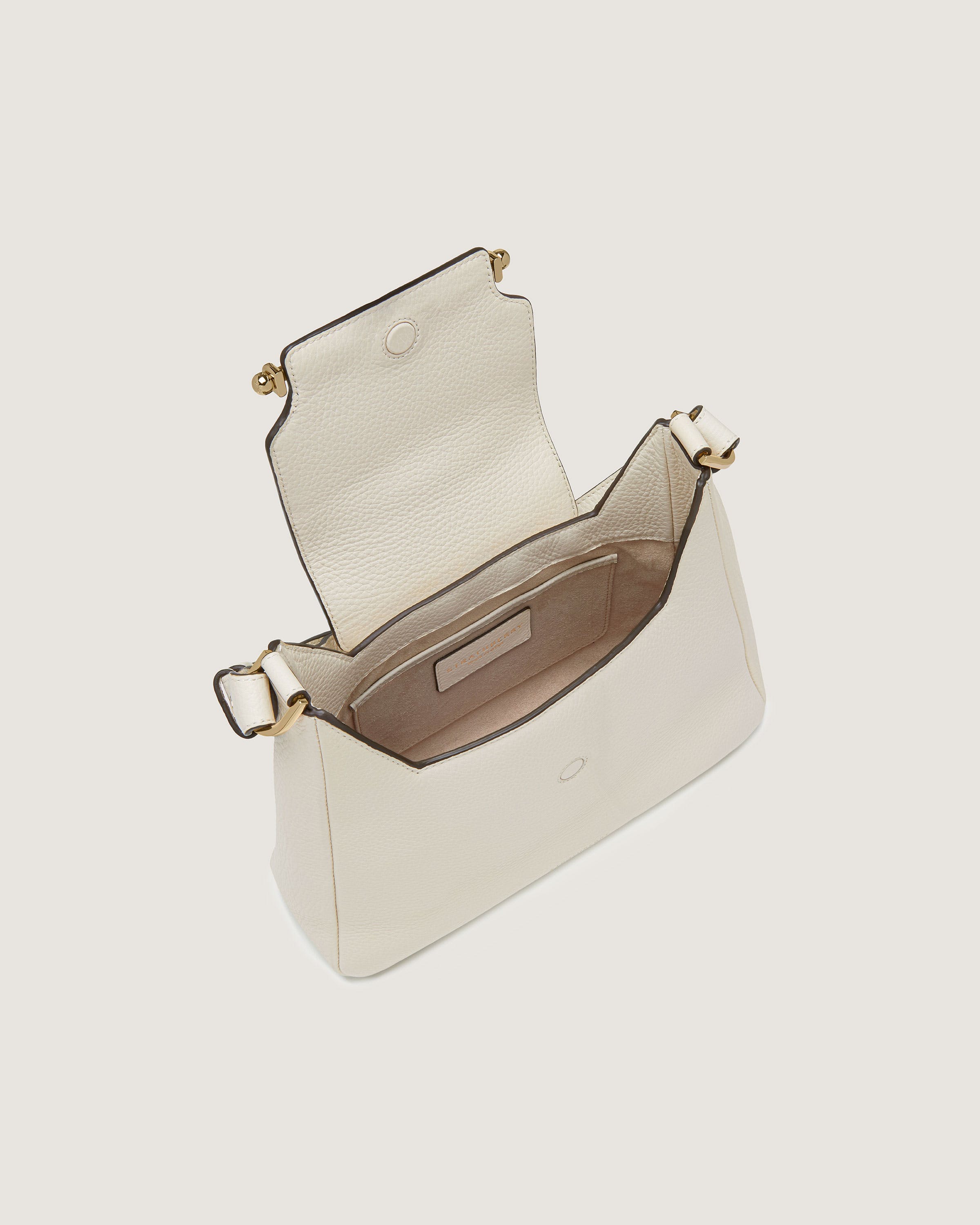 A white handbag with a gold handle