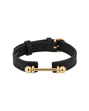 A black leather bracelet with gold hardware