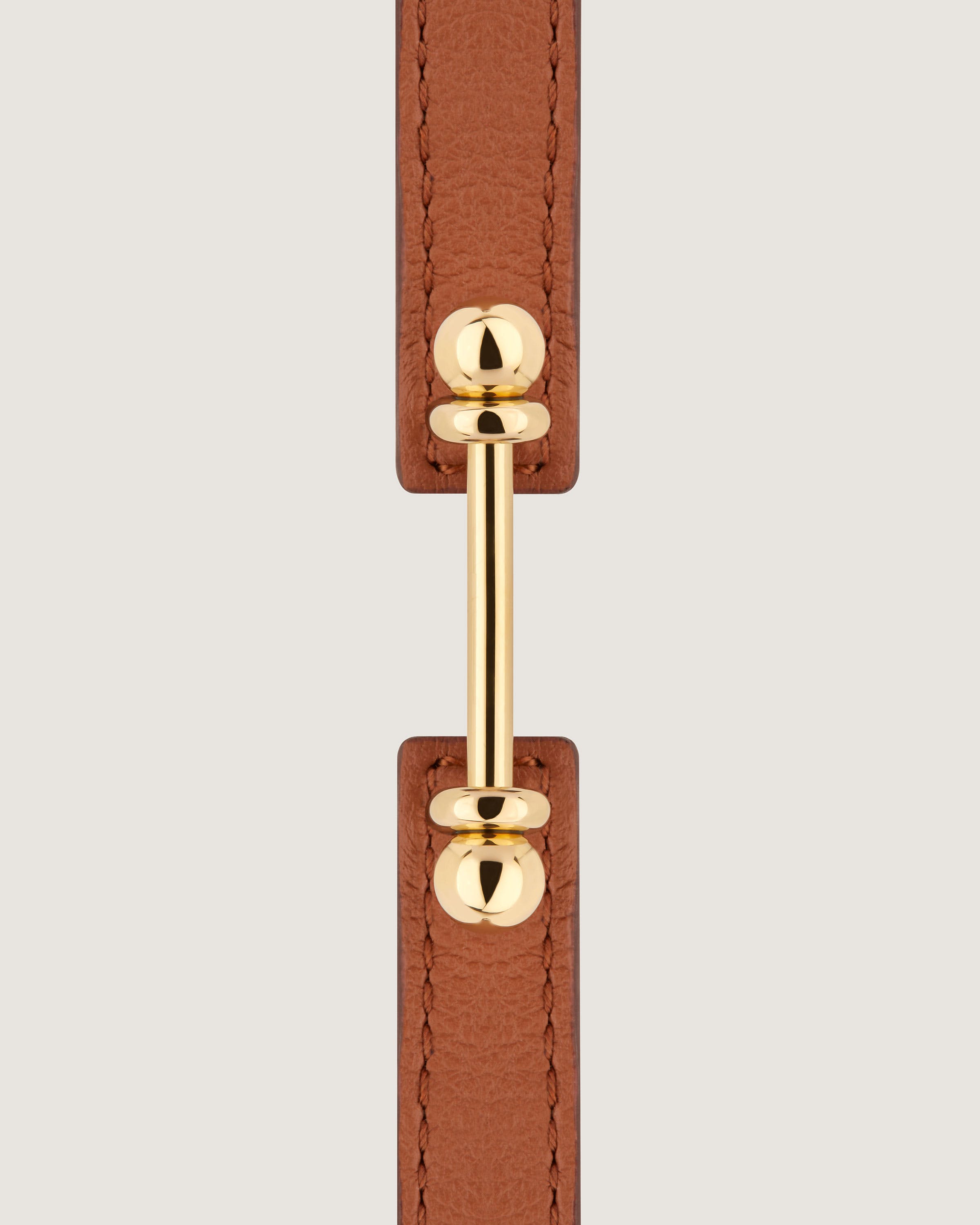 A brown leather belt with a gold buckle