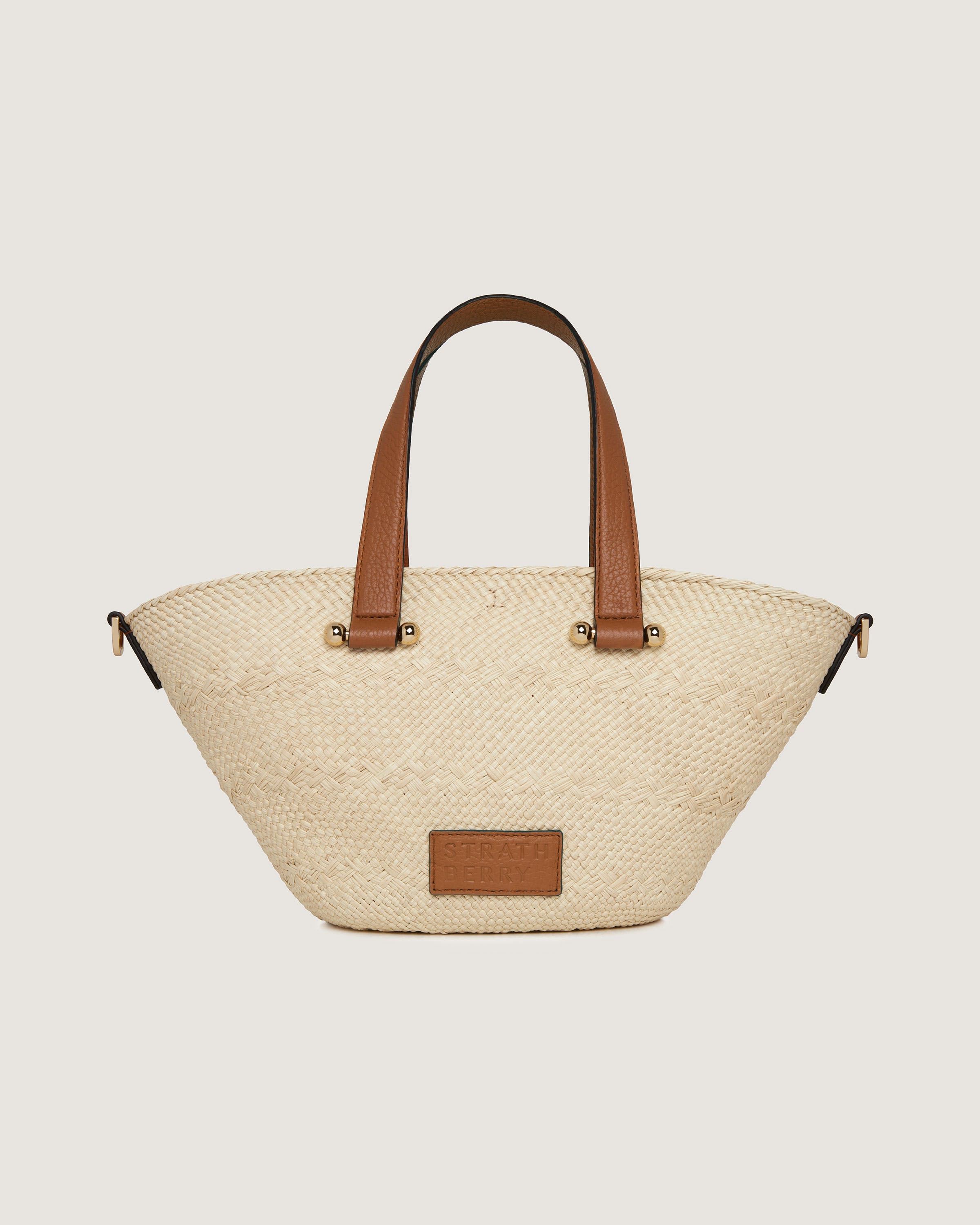 A white and brown handbag with a brown handle