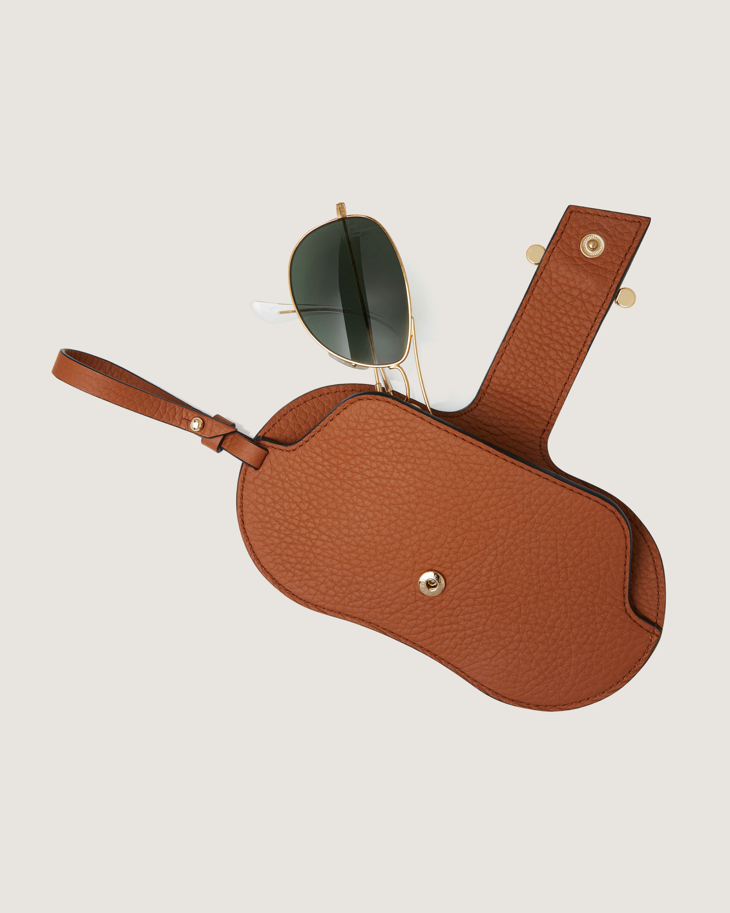 A pair of sunglasses sitting on top of a brown case