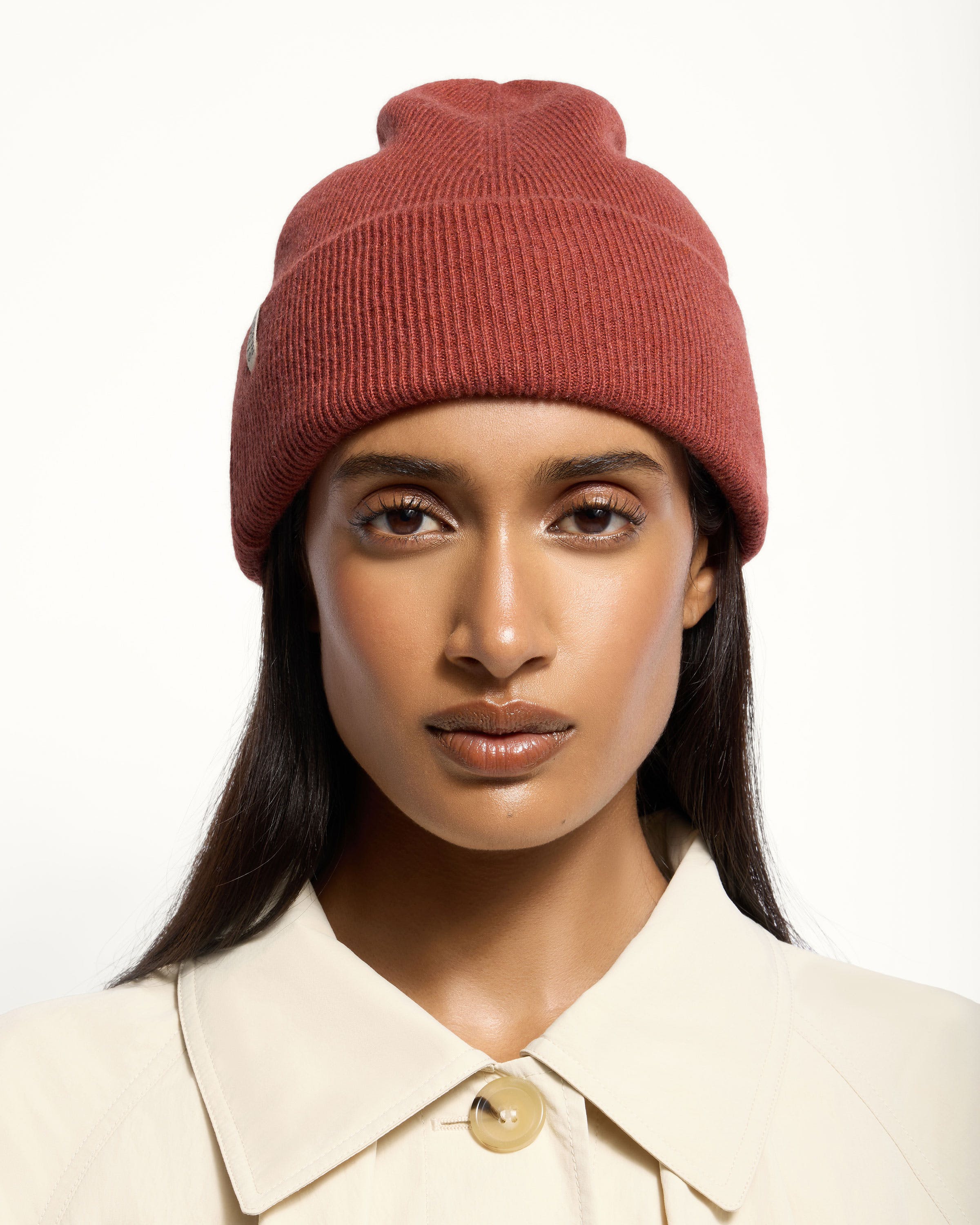 A woman wearing a red beanie hat