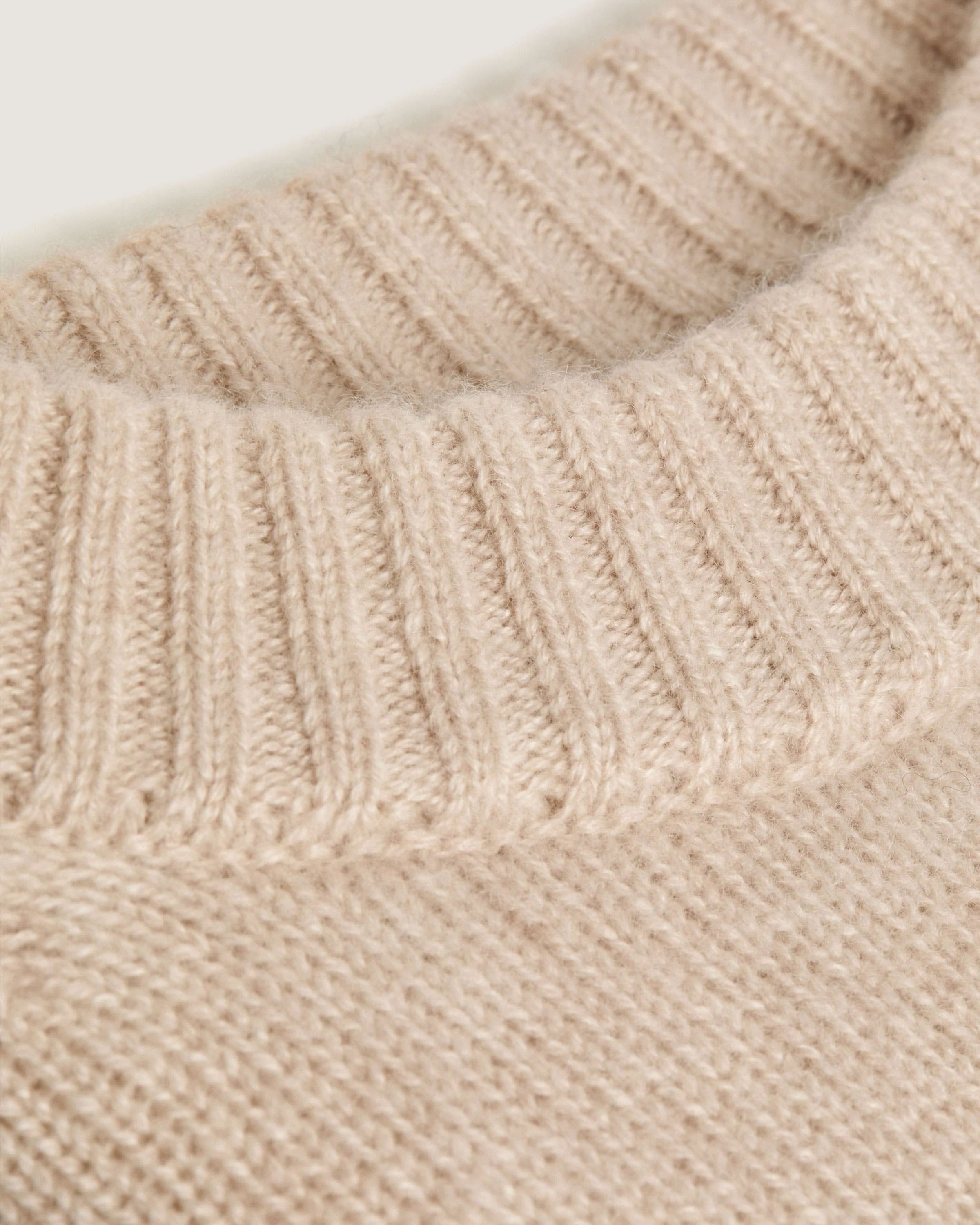 A close up of a sweater on a white background