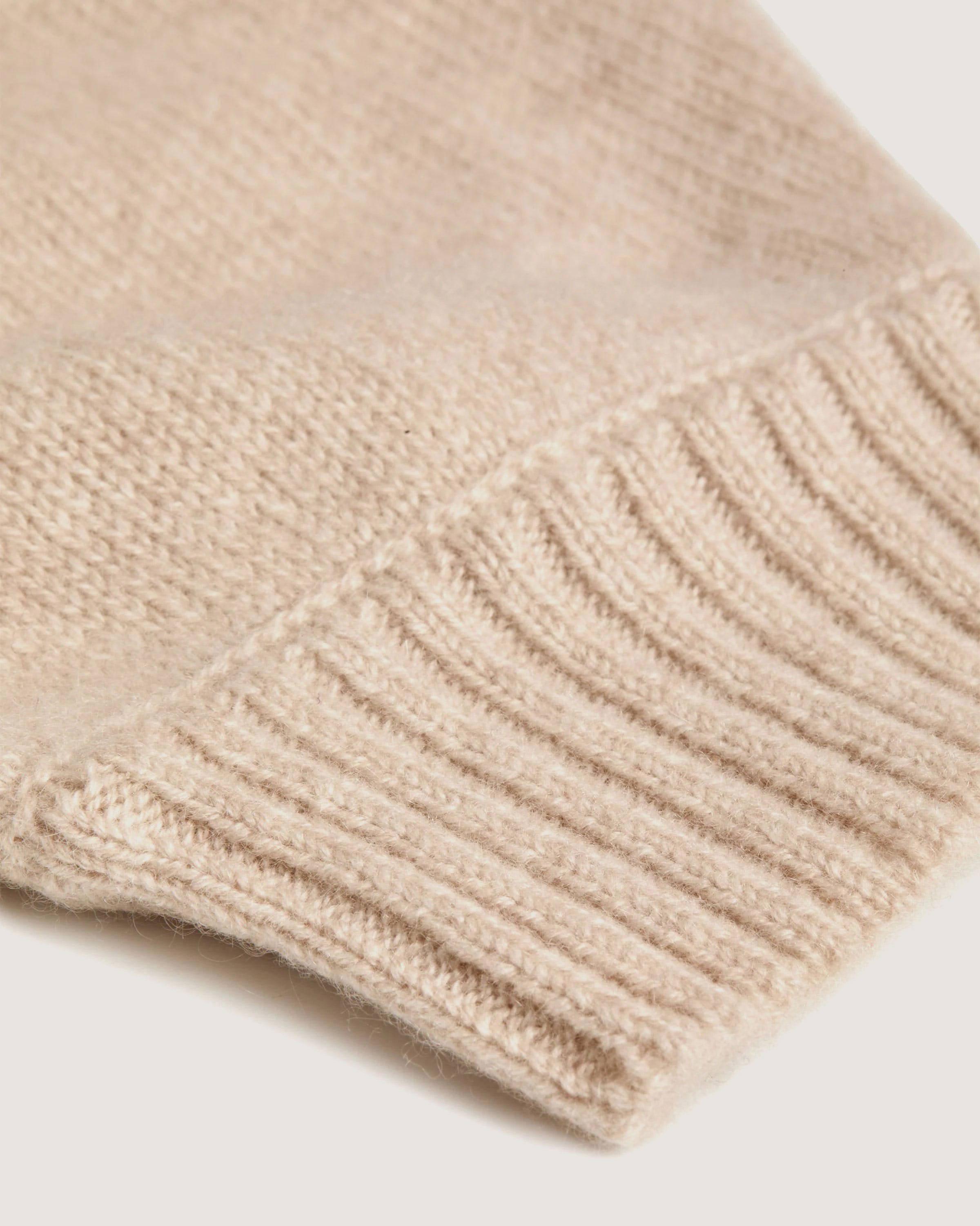 A close up of a sweater on a white surface