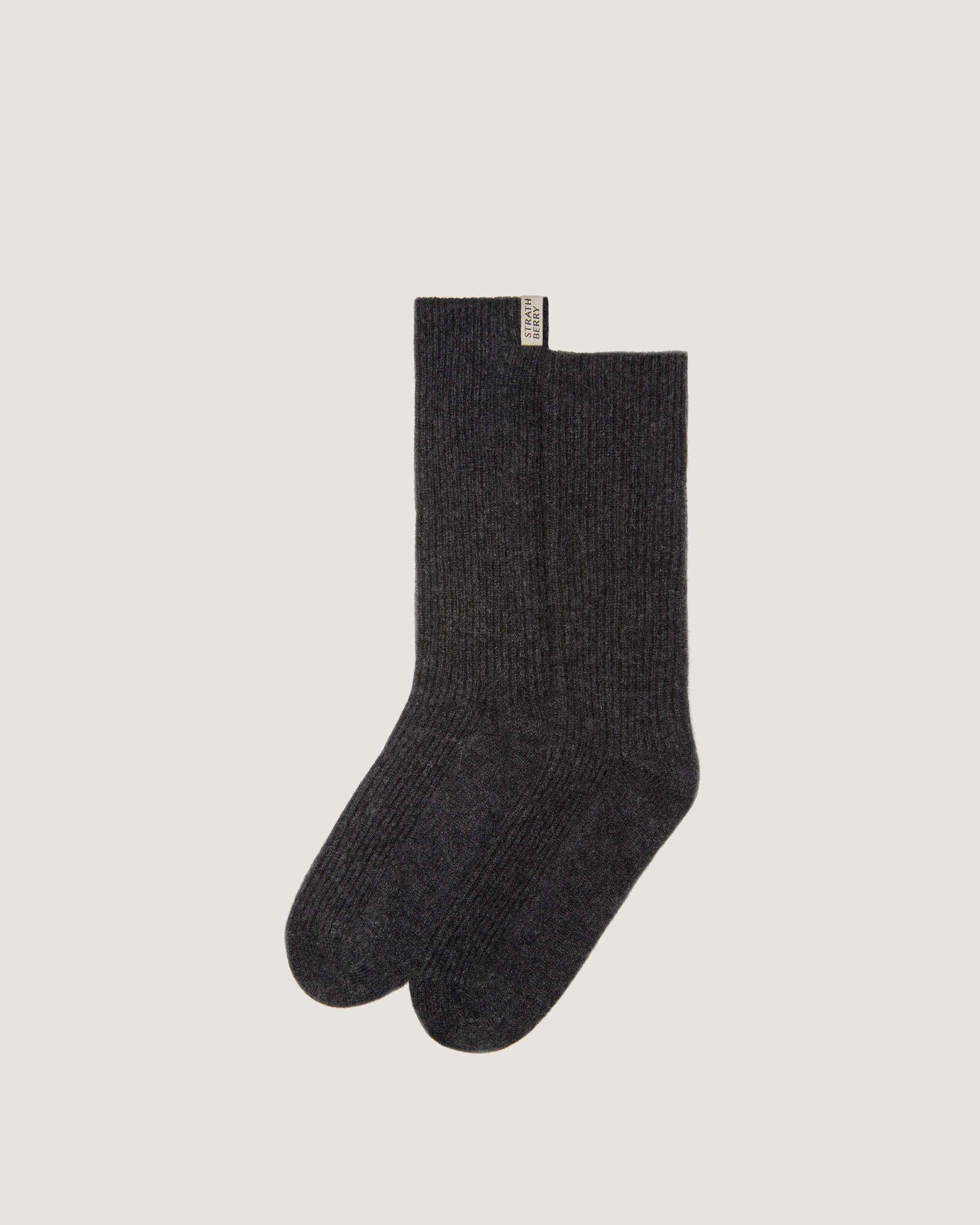 A pair of black socks on a white background