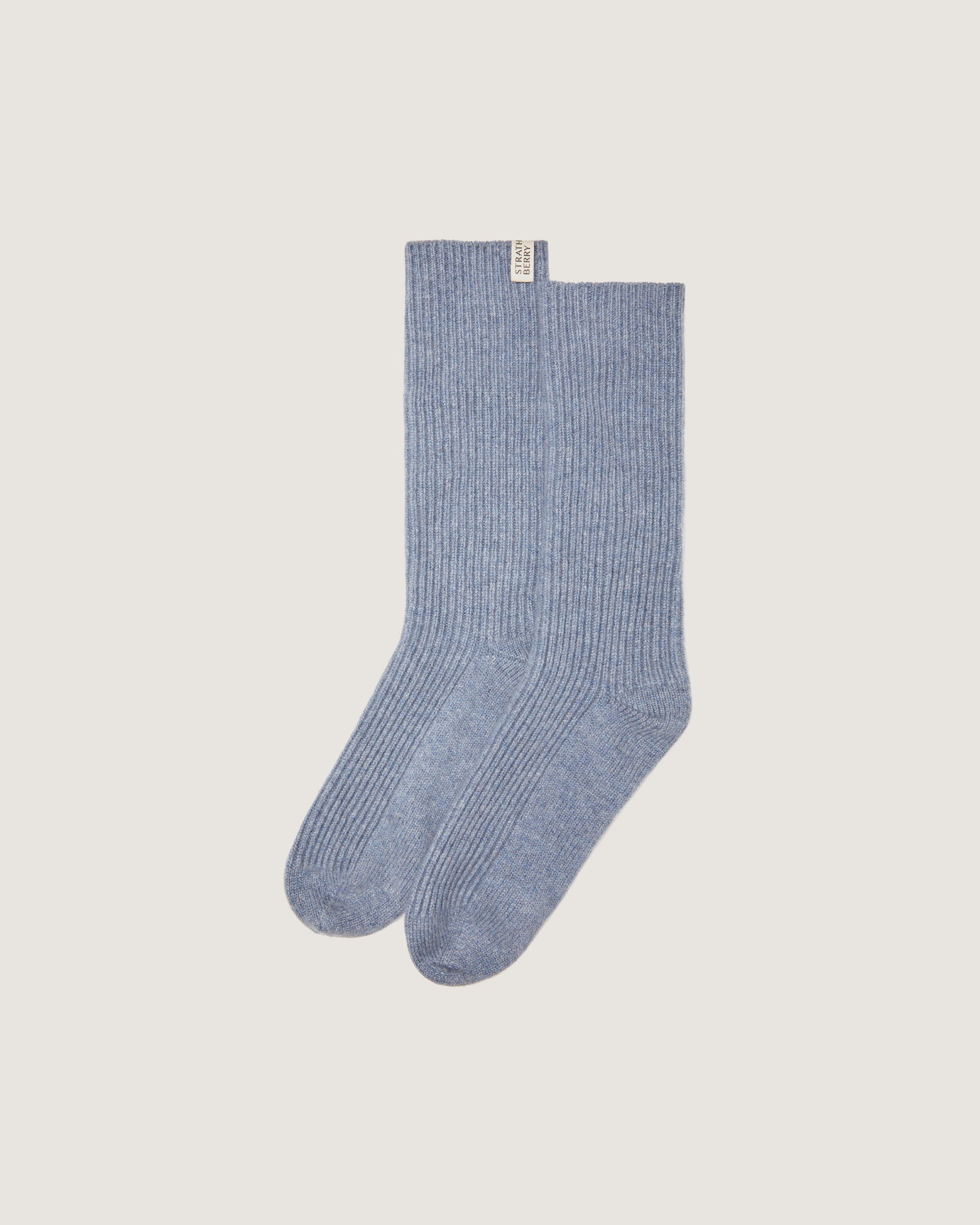 A pair of blue socks on a white background