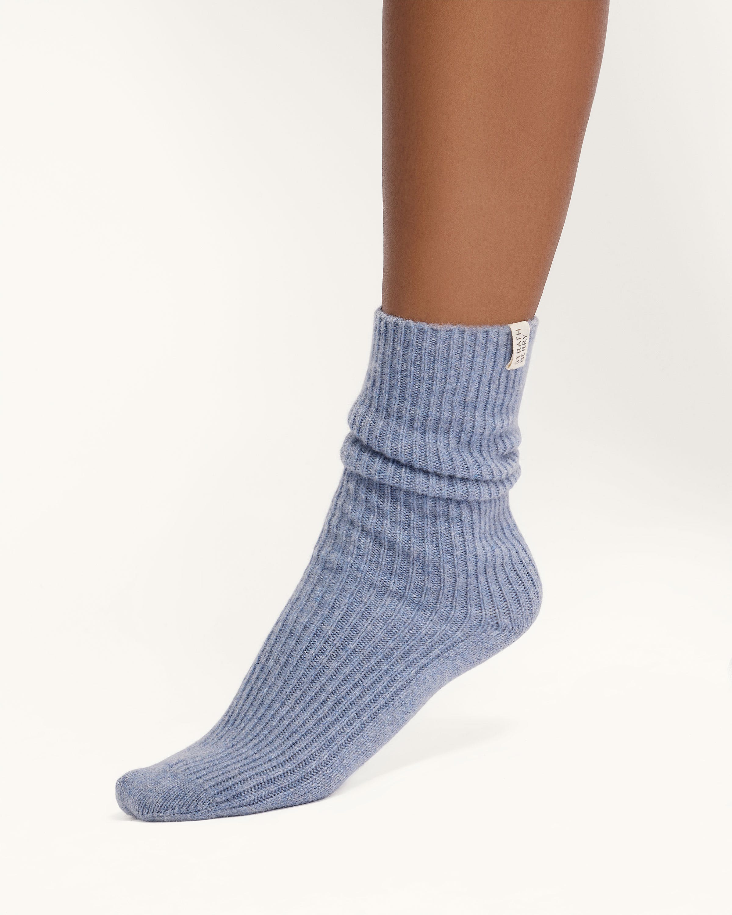 A person wearing a pair of blue socks