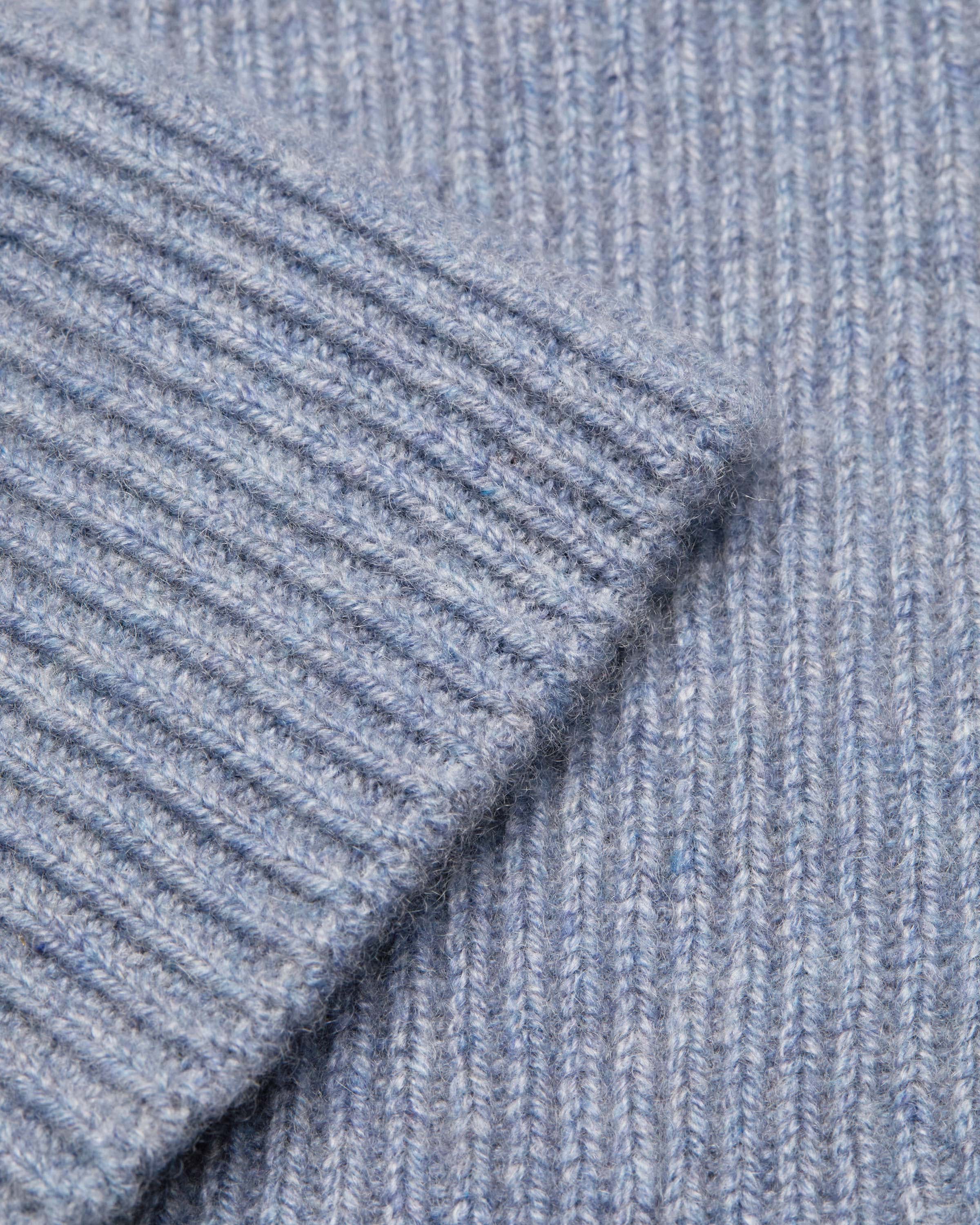 A close up view of a blue sweater