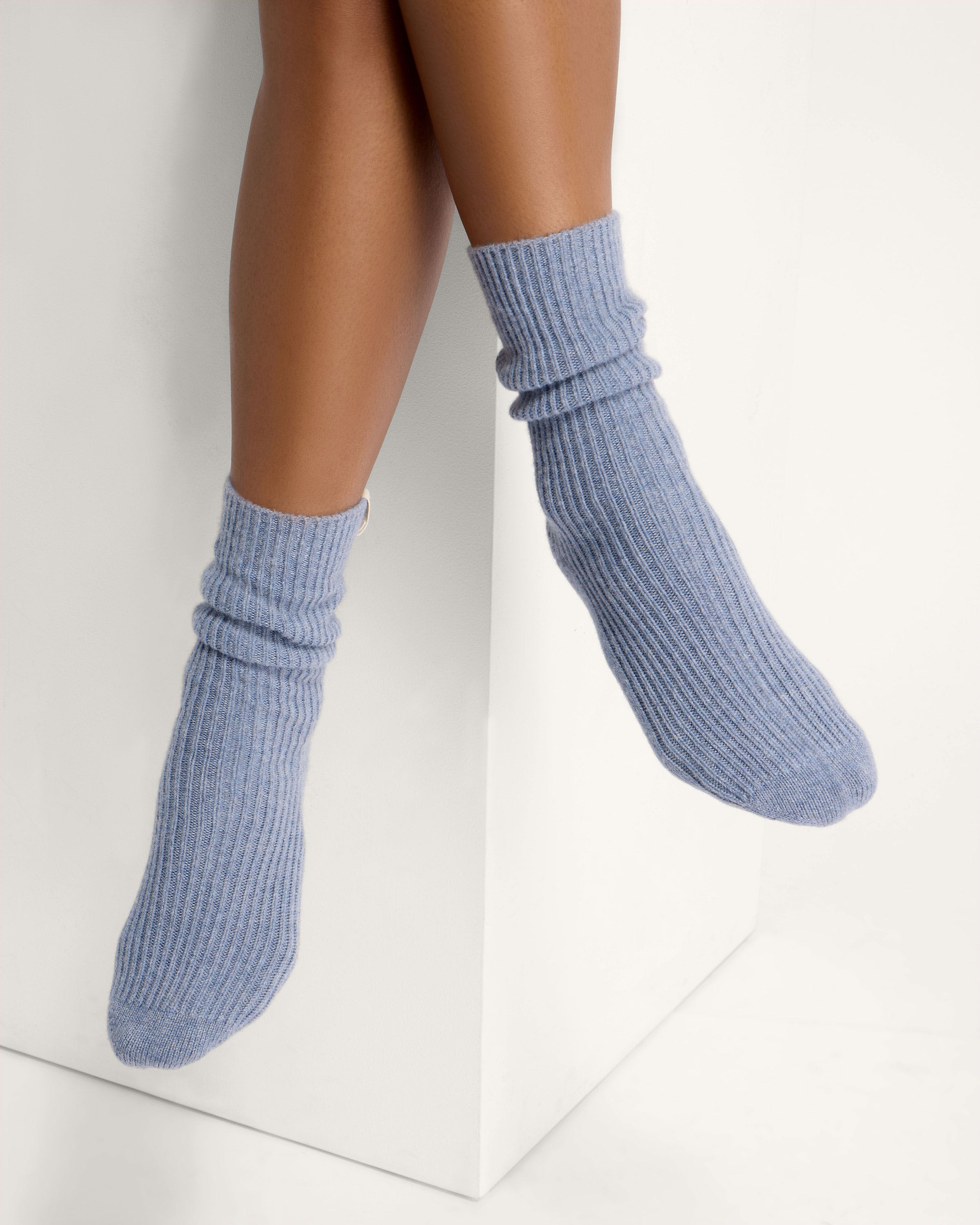 A woman's legs with a pair of blue socks