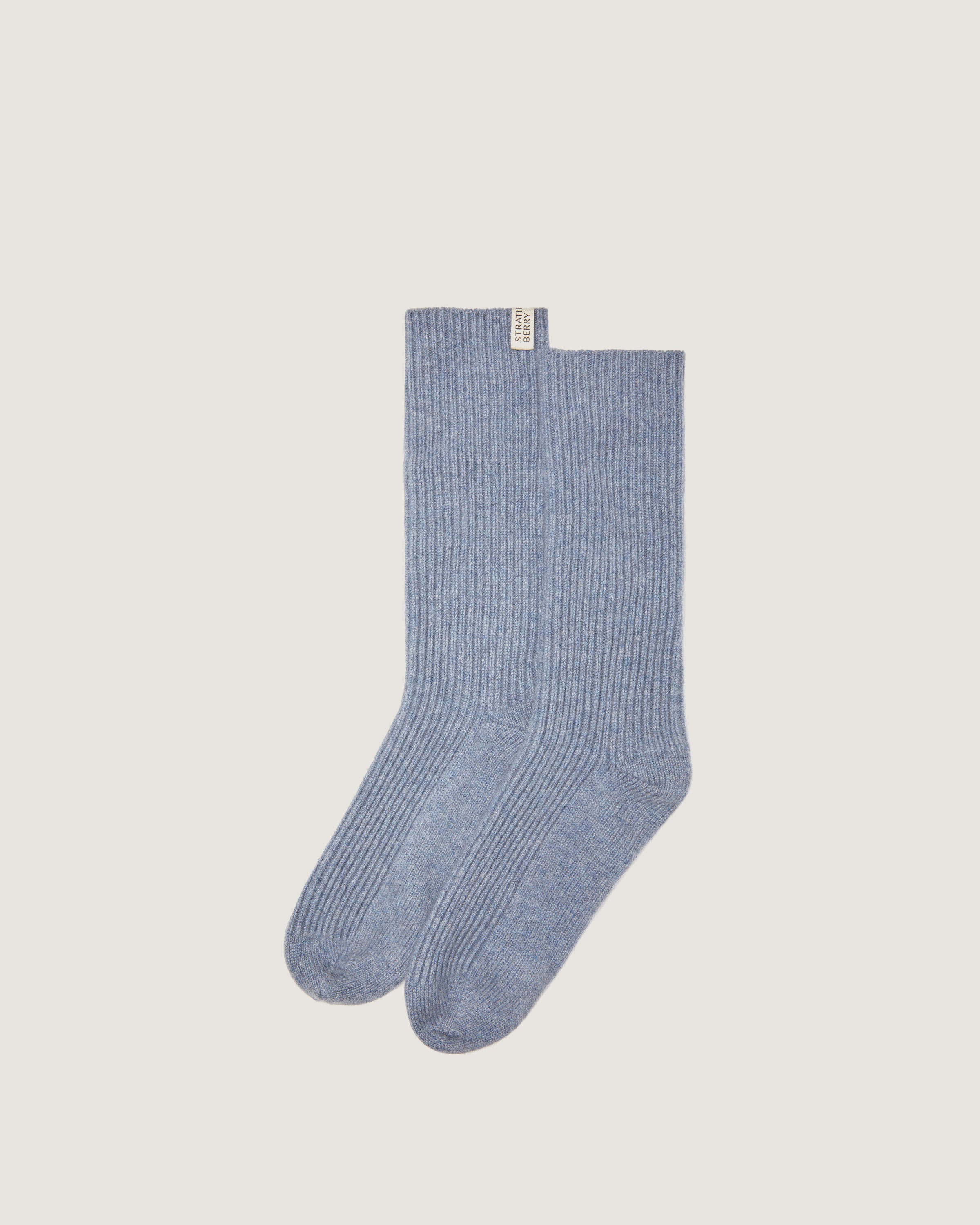 A pair of blue socks on a white background