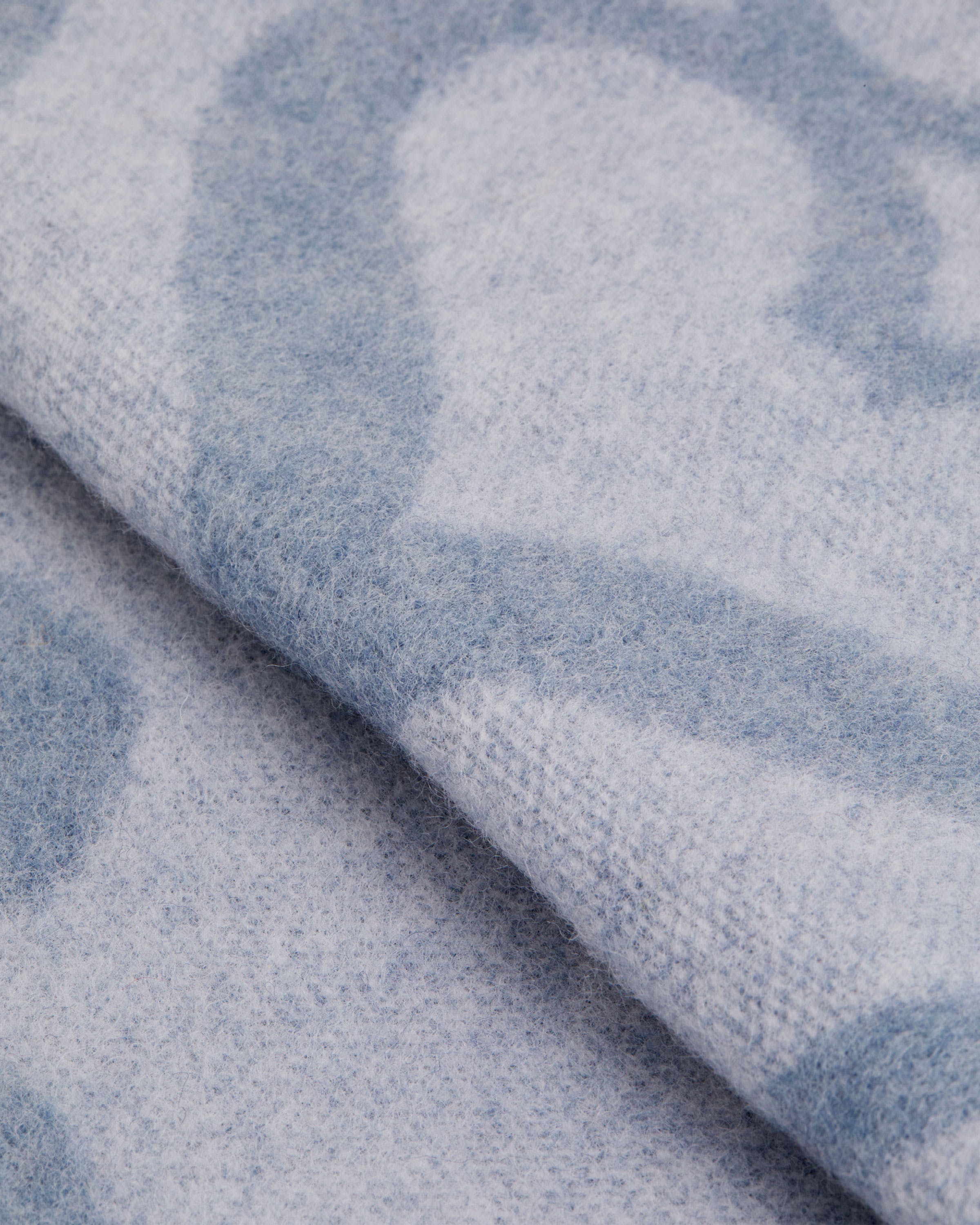 A close up of a blue and white blanket