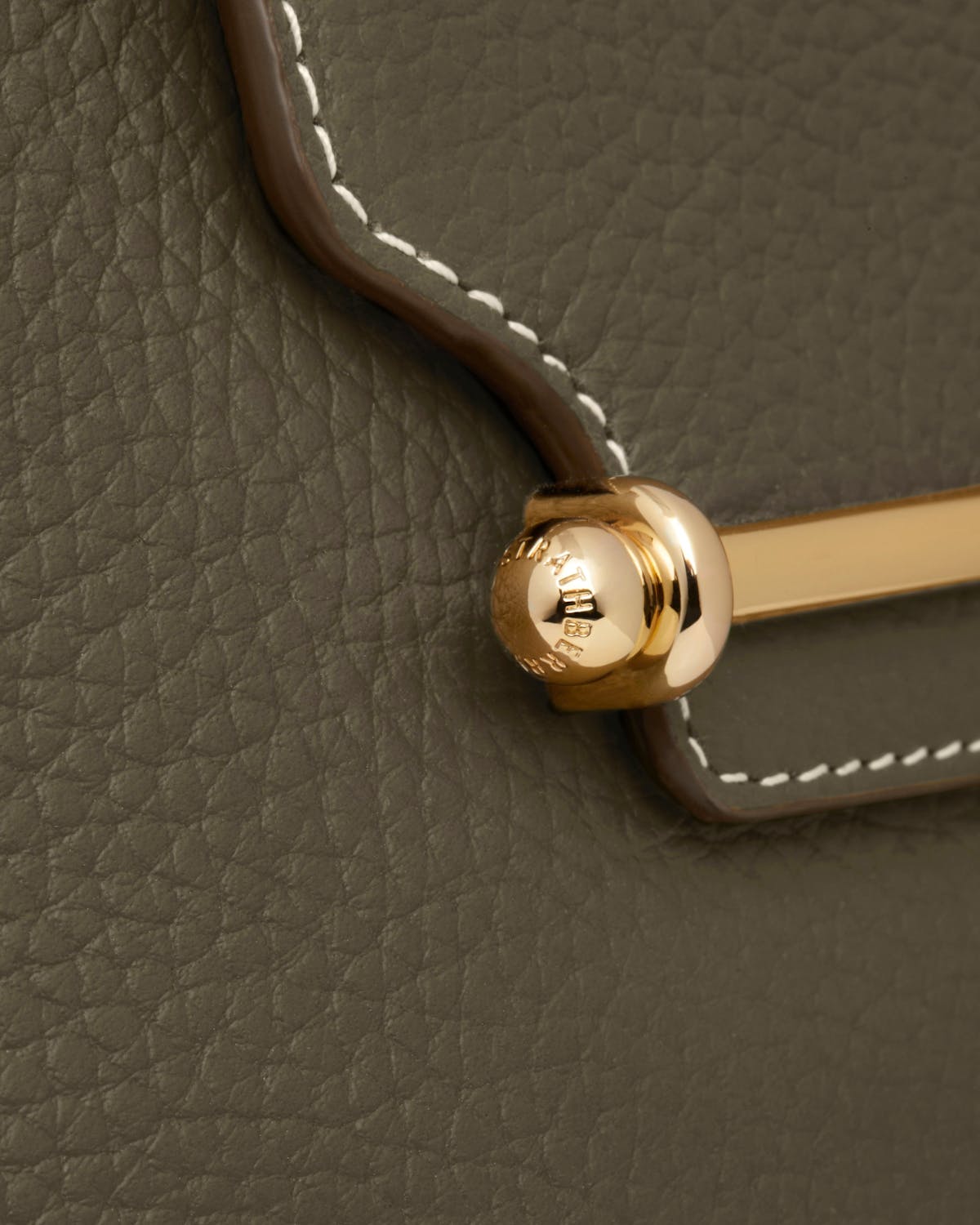 A close up of the handle of a purse