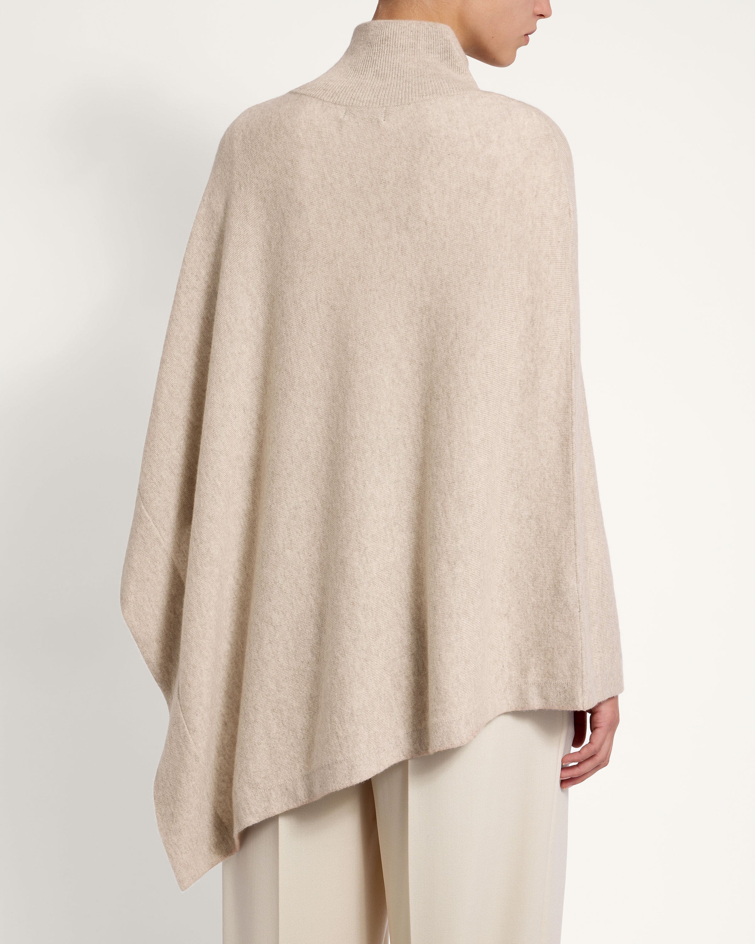 A woman wearing a beige poncho