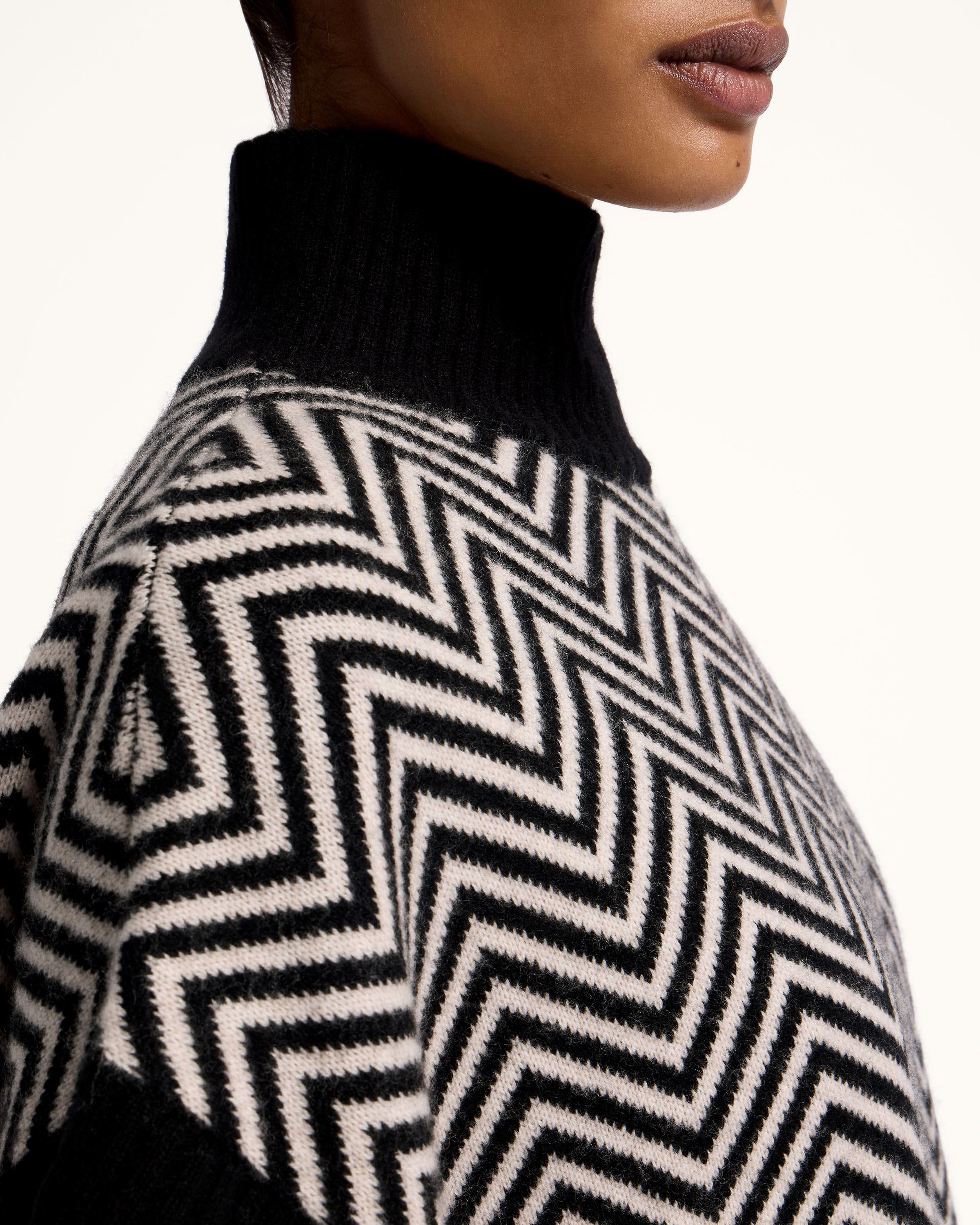 A woman wearing a black and white sweater