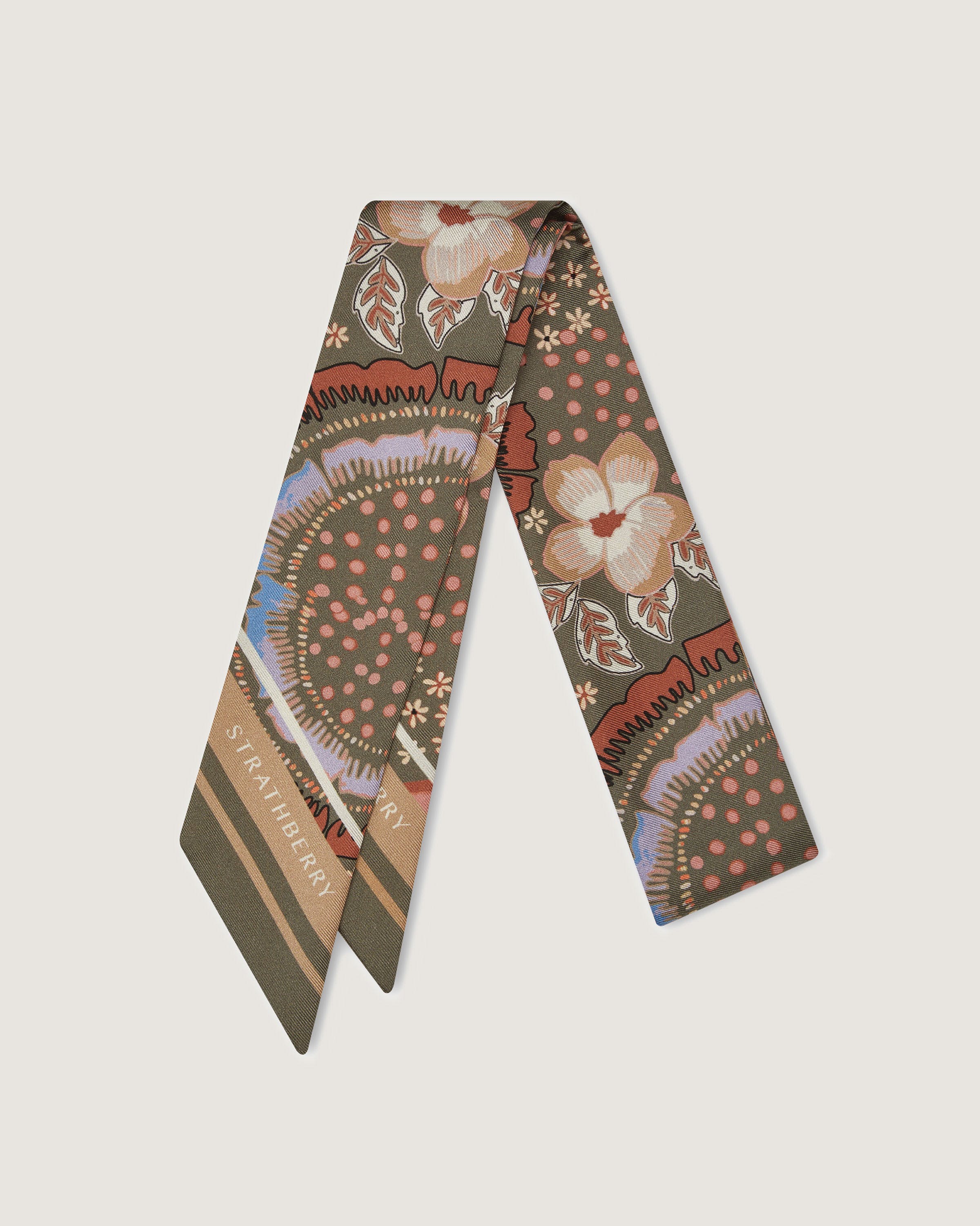 A neck tie with a flower design on it