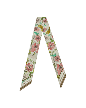 A white and pink flowered neck tie on a green background