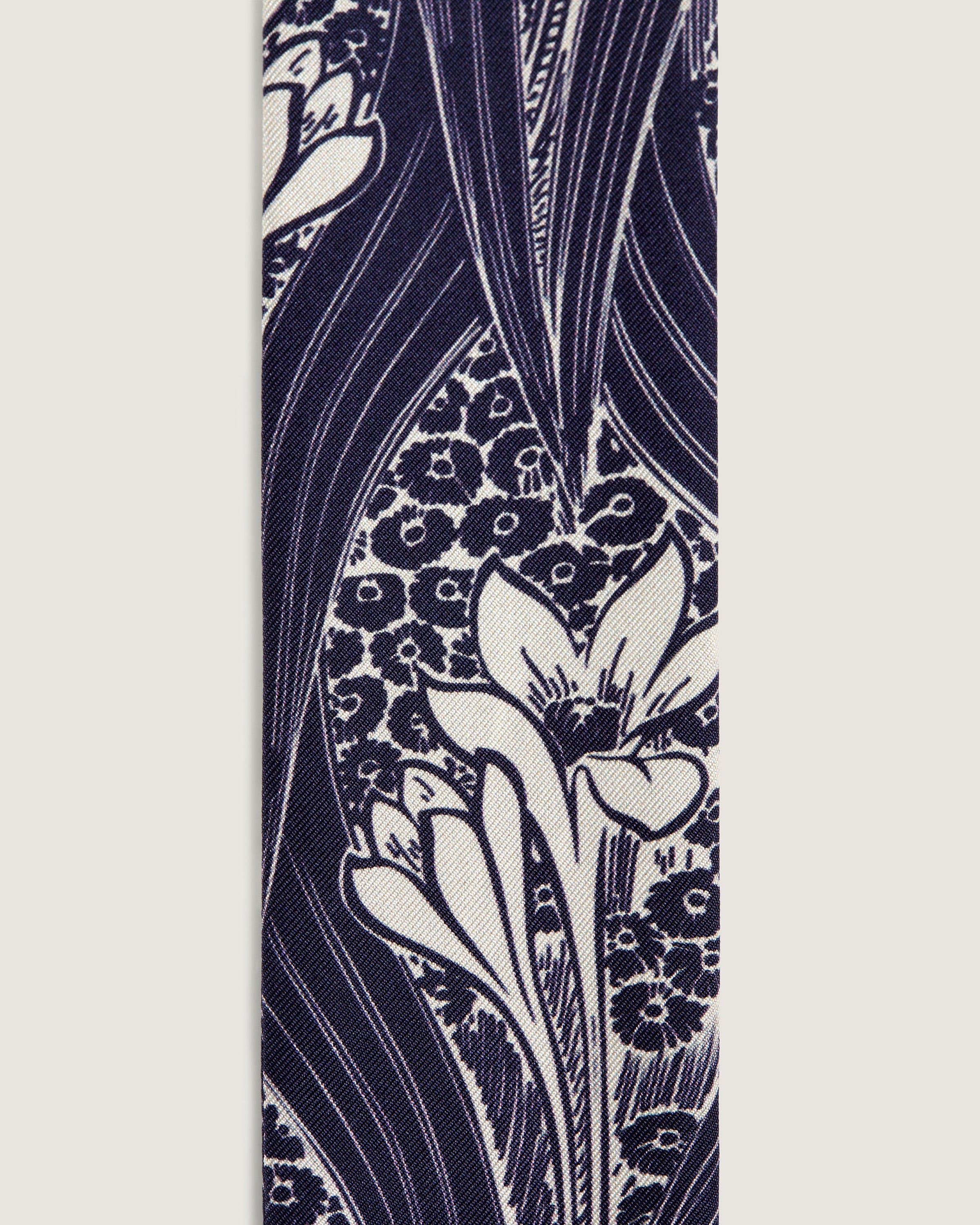 A blue and white tie with flowers on it