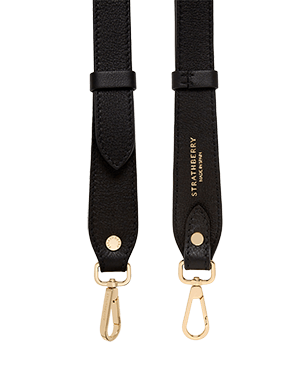 A pair of black leather straps with gold hardware