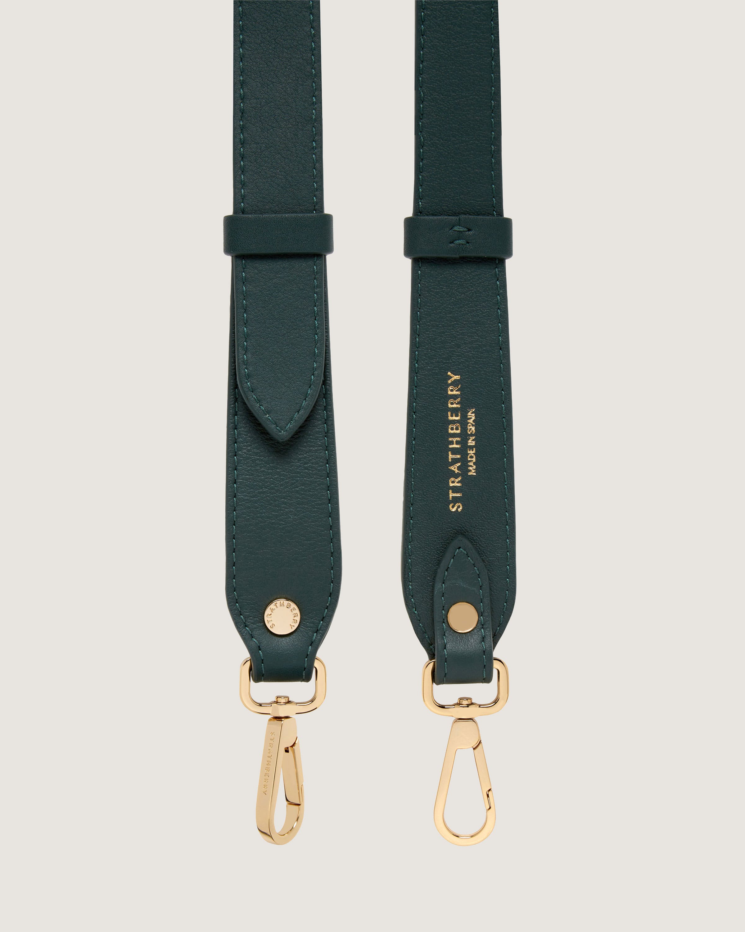 A pair of green leather straps with gold hardware